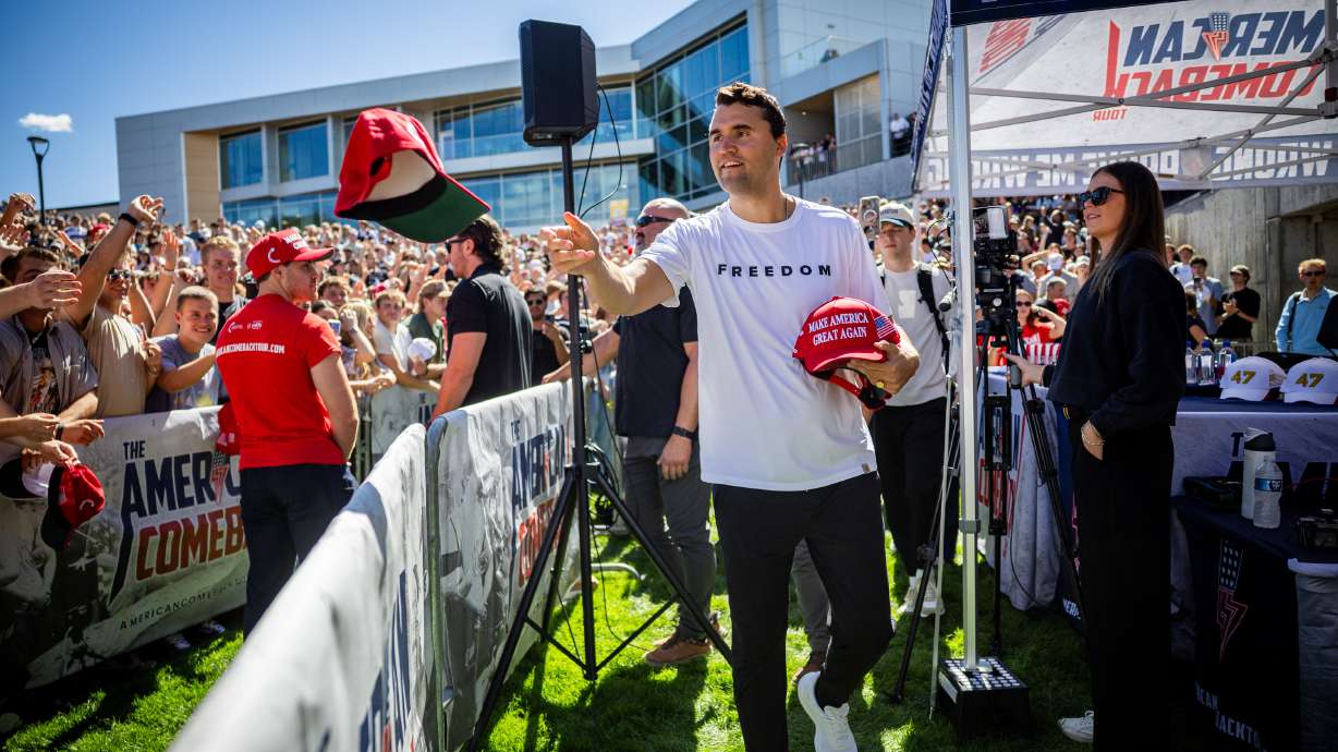 Charlie Kirk hands out hats before he was shot during Turning Point USA’s visit to Utah Valley University in Orem on Sept. 10, 2025. UVU won't hold classes on Sept. 10, the first anniversary of the killing of Kirk.