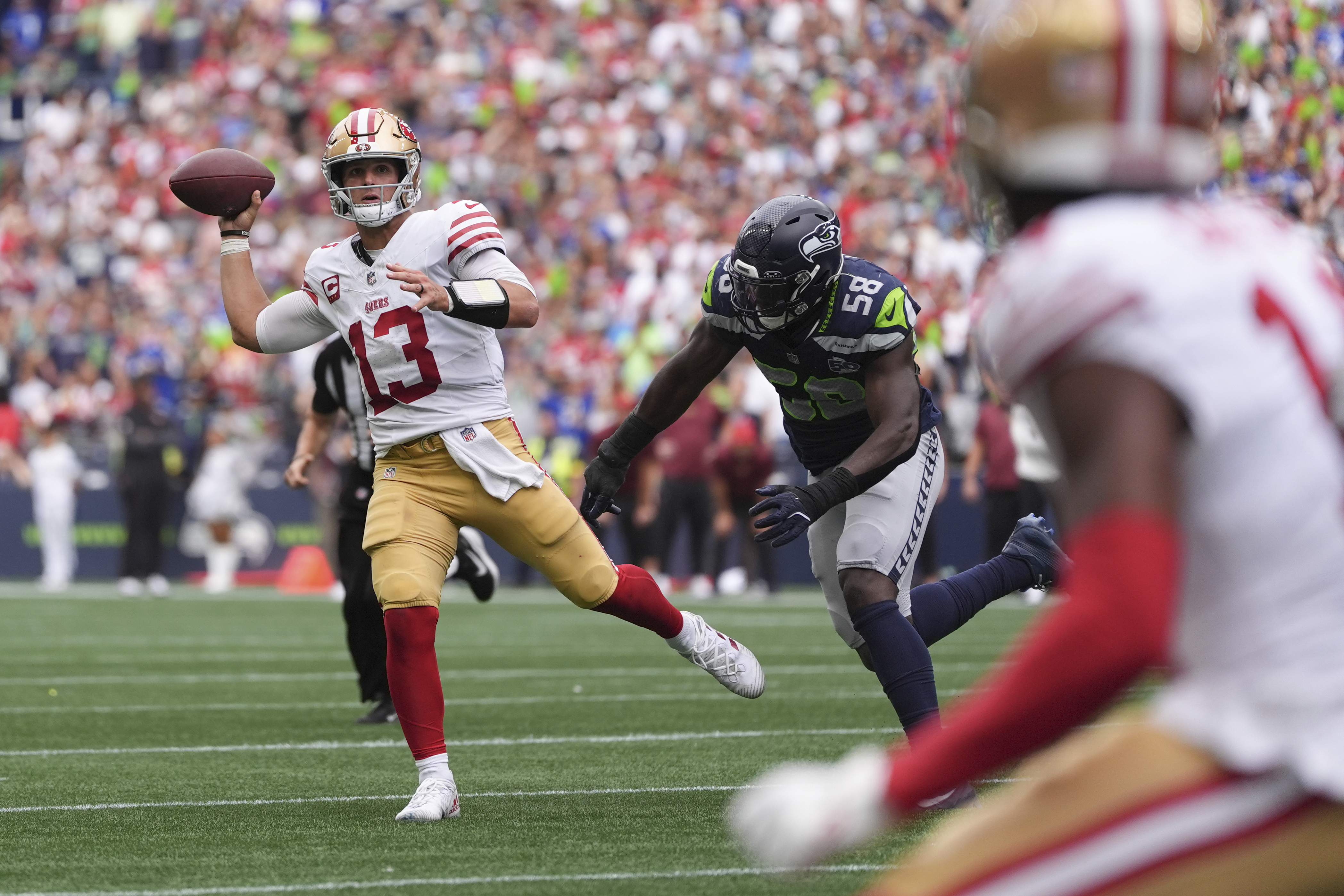 San Francisco 49ers quarterback Brock Purdy (13) throws during the second half of an NFL football game against the Seattle Seahawks, Sunday, Sept. 7, 2025, in Seattle. 
