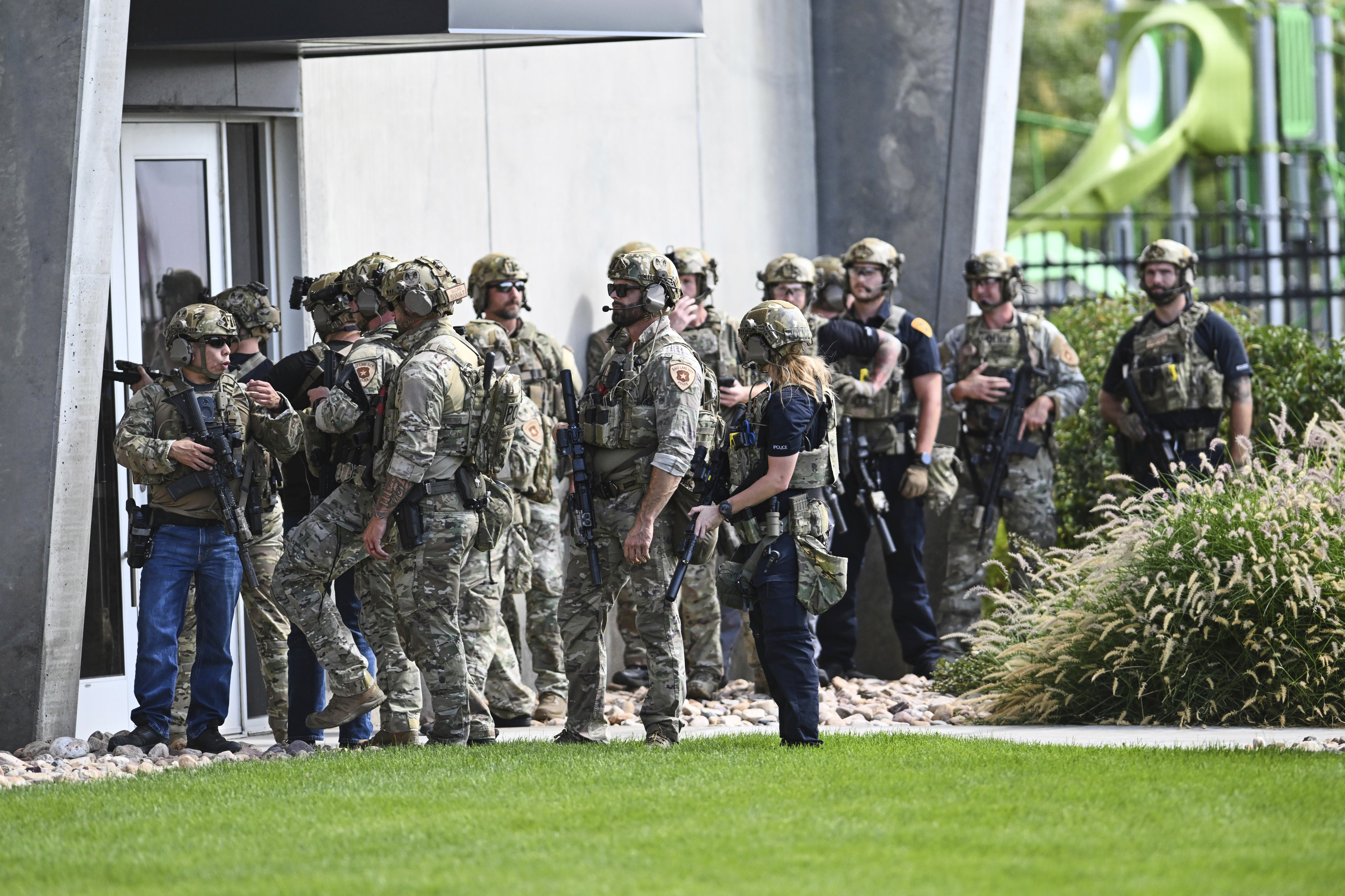 Law enforcement officials prepare to sweep a building at Utah Valley University, Wednesday.