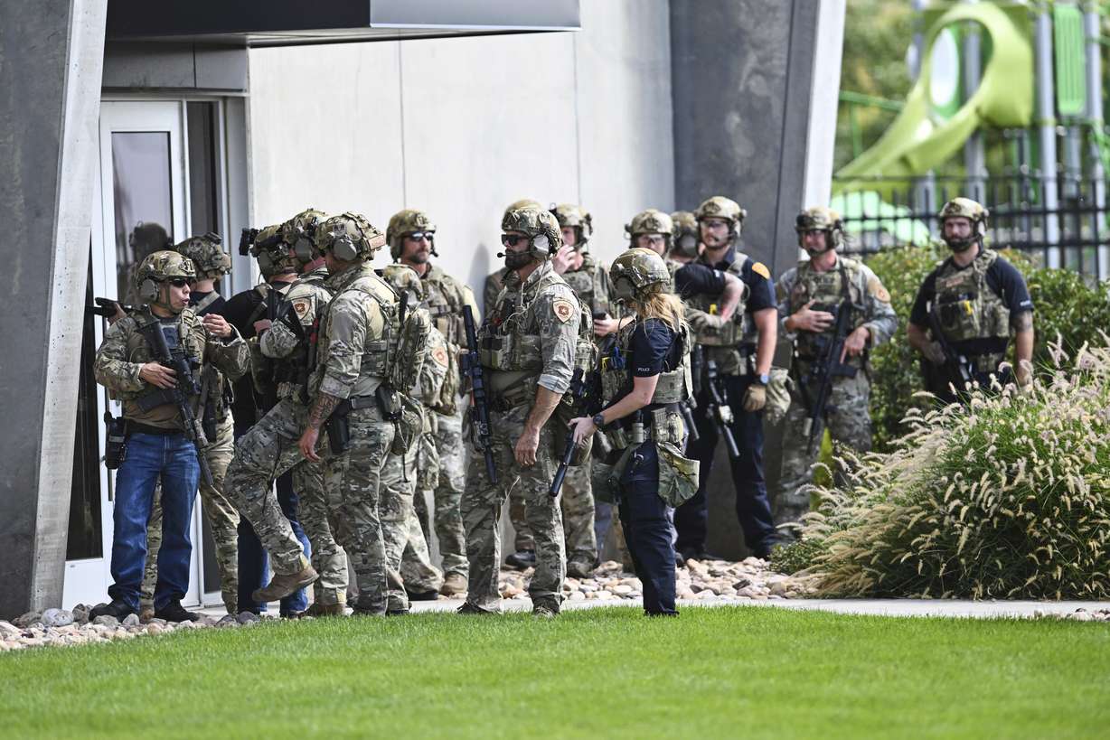 Law enforcement officials prepare to sweep a building at Utah Valley University, Wednesday.