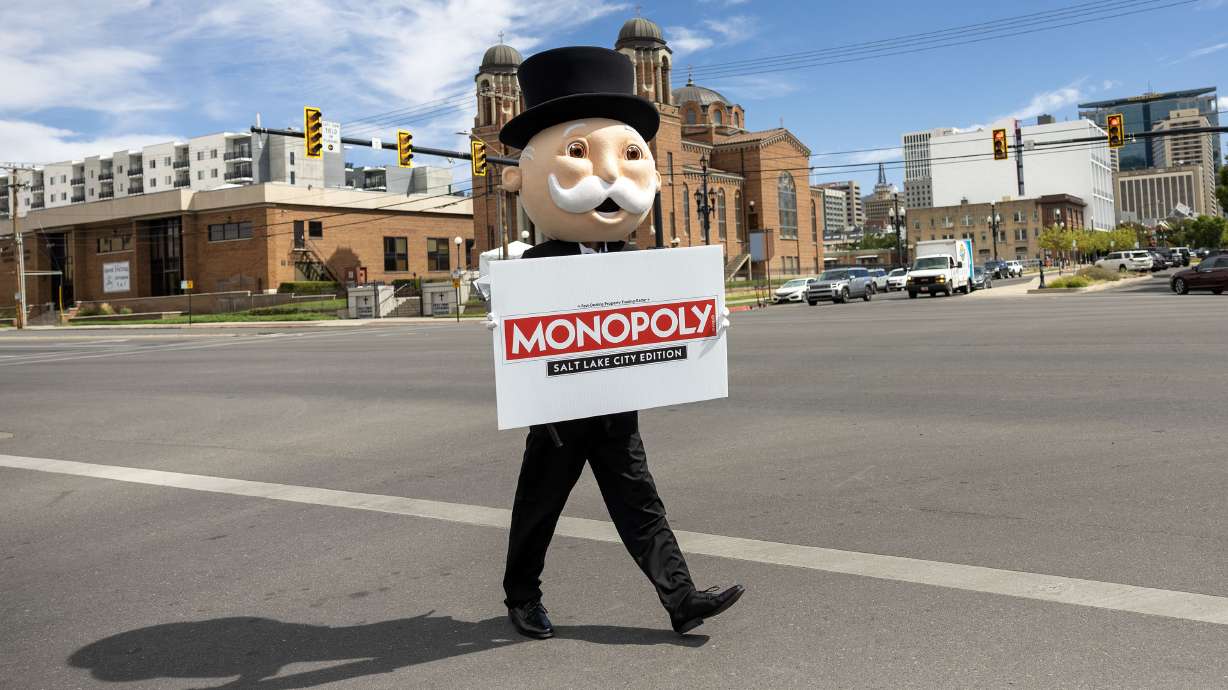 Mr. Monopoly walks across 300 West in Salt Lake City after an announcement that a Monopoly: Salt Lake City Edition will debut in the summer of 2026 on Wednesday.