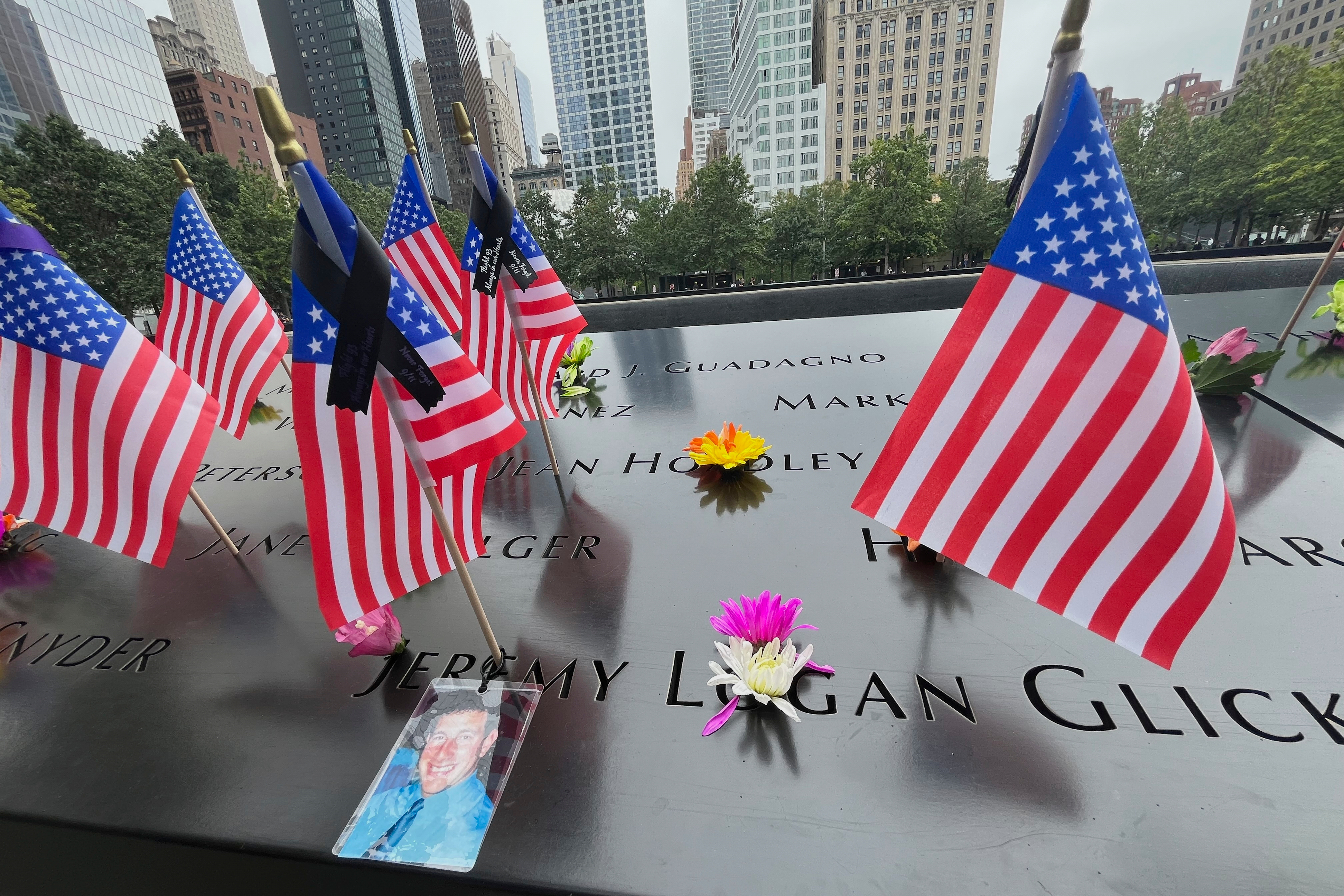 Flags and flowers are placed in the inscribed names at the National Sept. 11 Memorial in New York on Wednesday.