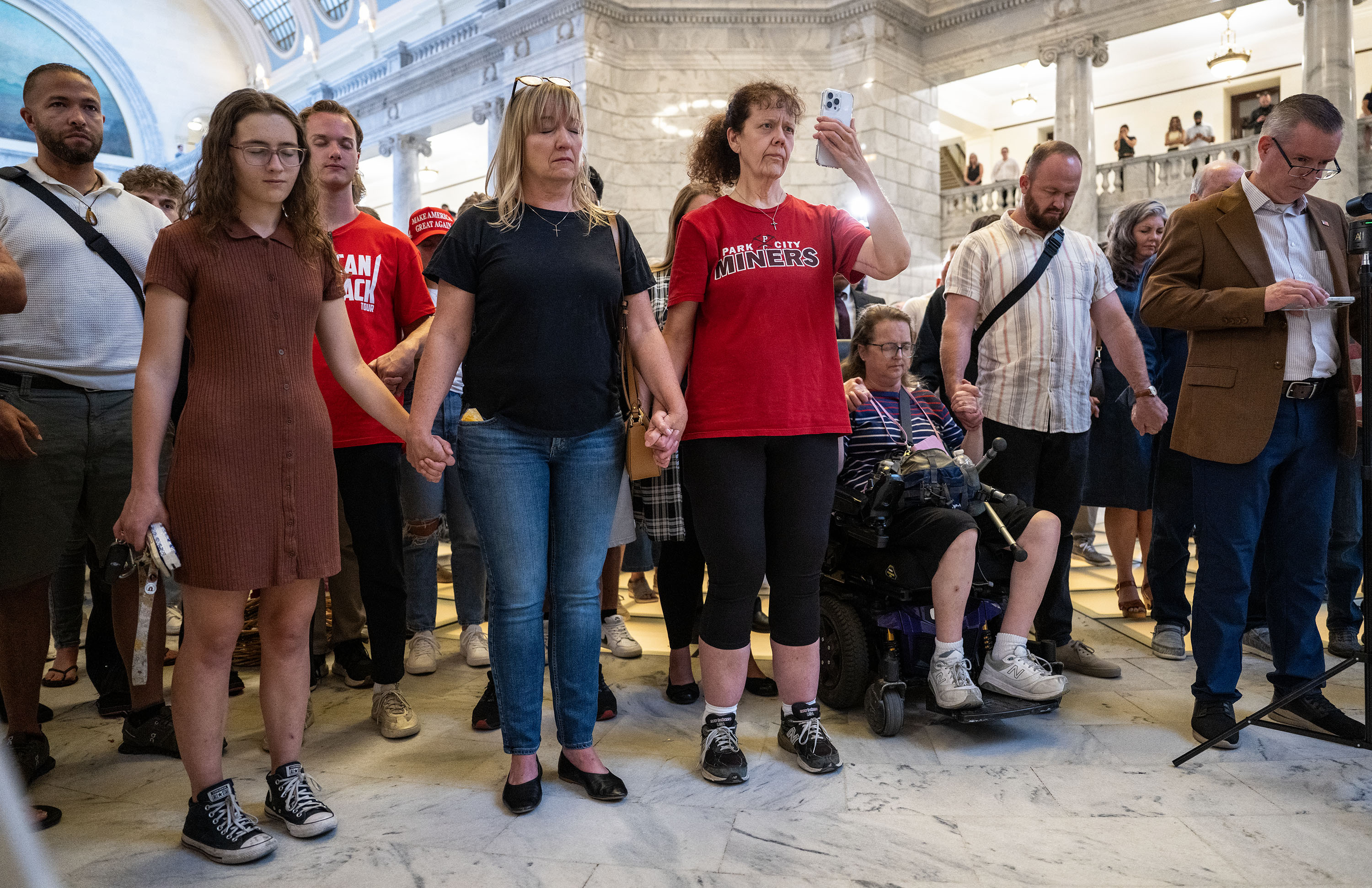 Hand in hand members of the community gather in prayer at the Capitol in Salt Lake City, during a vigil to honor Charlie Kirk after he was shot at an event at Utah Valley University and later died at a local hospital on Wednesday.