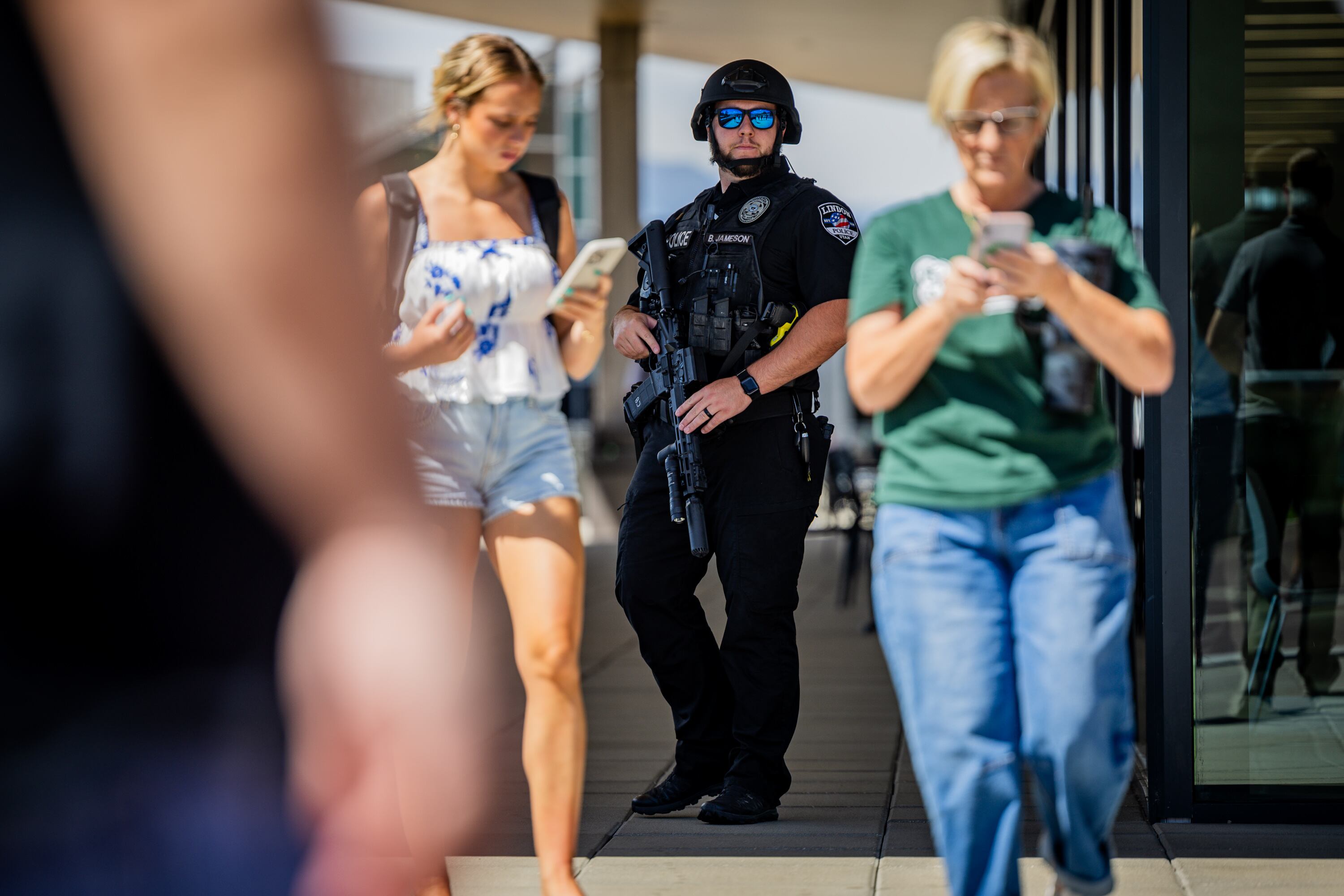 A member of the Lindon Police Department works the scene after Charlie Kirk was shot during Turning Point USA’s visit to Utah Valley University in Orem on Wednesday. The shooting raises questions about what security measures were in place.