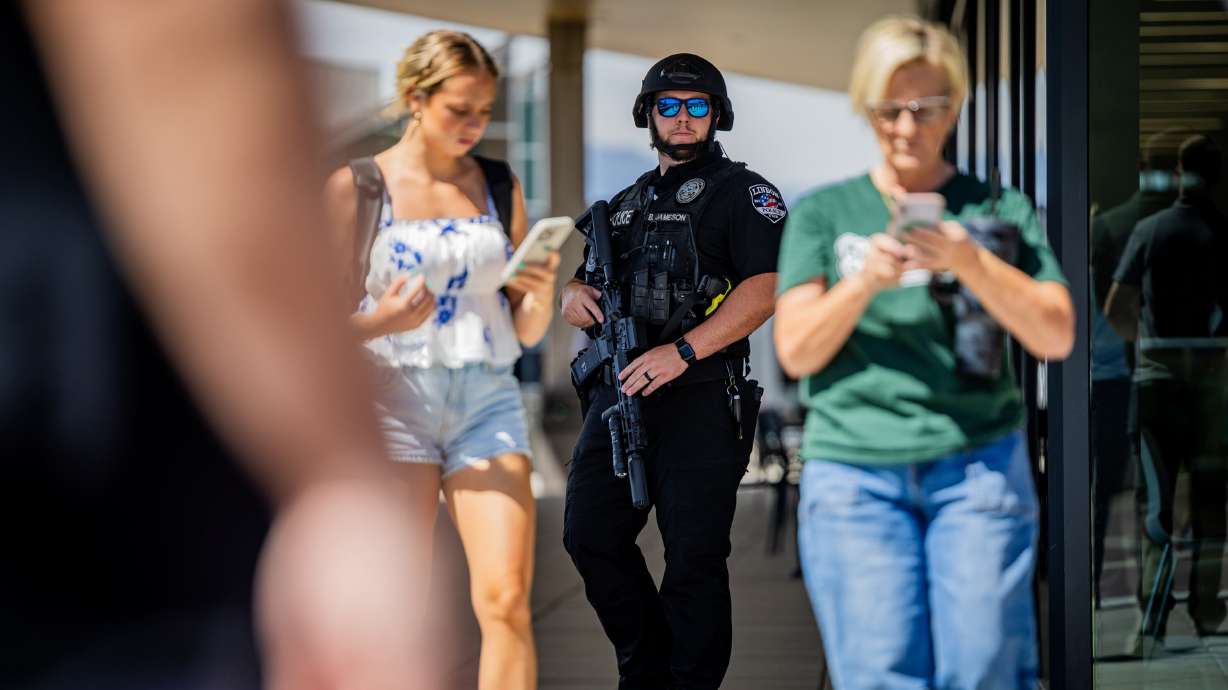 A member of the Lindon Police Department works the scene after Charlie Kirk was shot during Turning Point USA’s visit to Utah Valley University in Orem on Wednesday. The shooting raises questions about what security measures were in place.