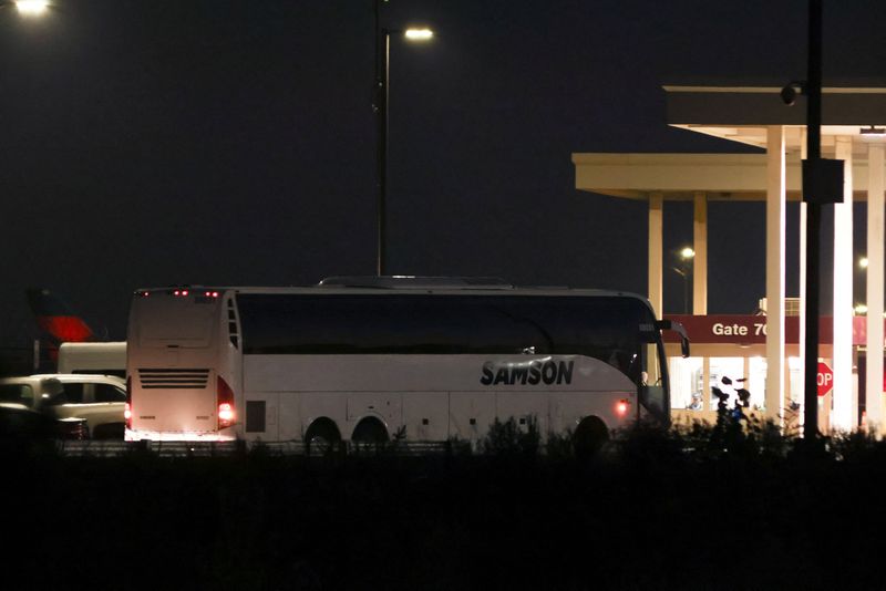 A bus transporting workers detained in a huge immigration raid last week on a car battery plant arrives at Hartsfield-Jackson Atlanta International Airport, where they are expected to board a South Korean chartered plane sent to repatriate them, in Atlanta, Ga., Thursday.