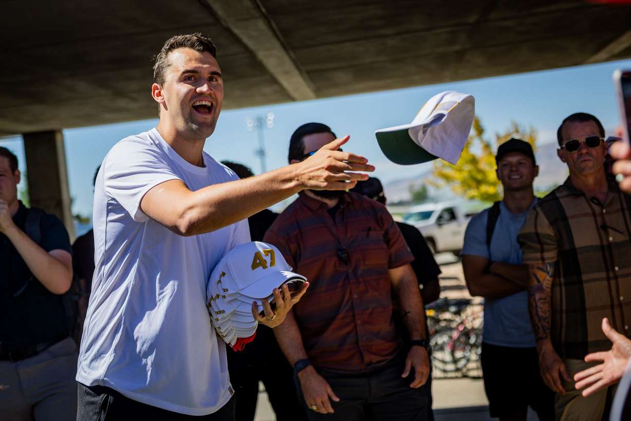 Charlie Kirk, the CEO and co-founder of the conservative youth organization Turning Point USA, hands out hats before he is fatally shot during Turning Point USA’s visit to Utah Valley University in Orem on Wednesday.