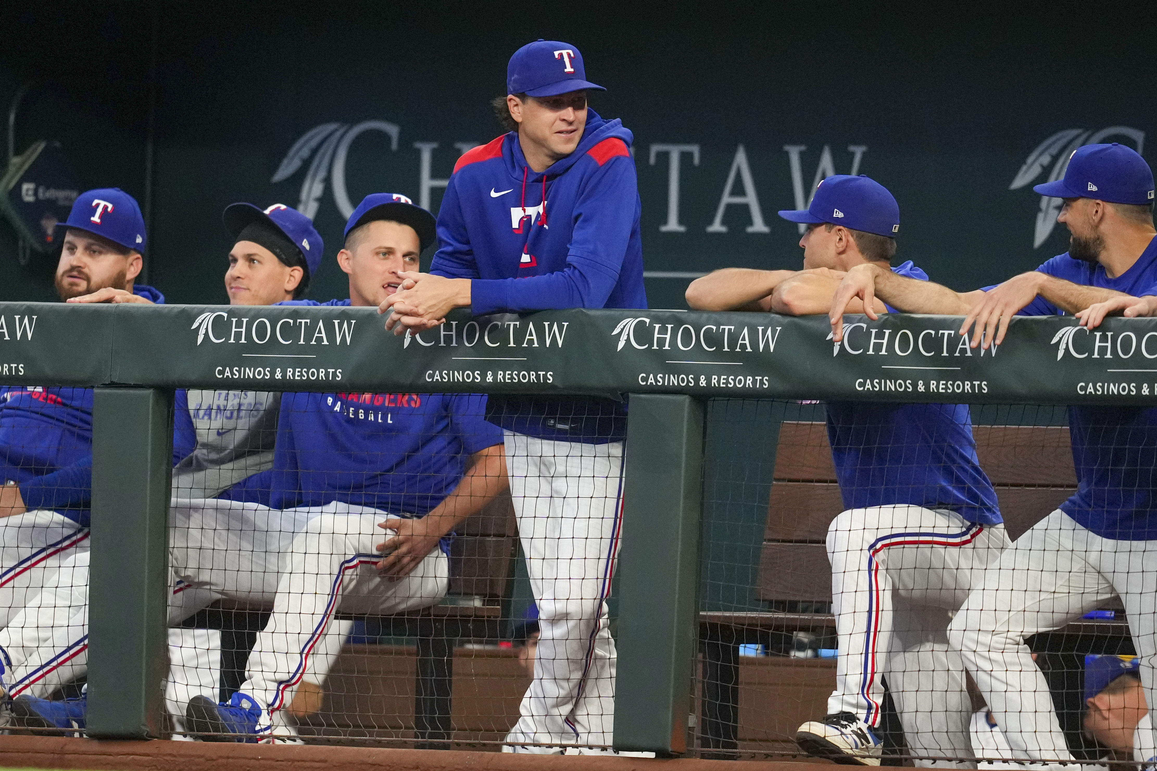 Texas Rangers pitcher Jacob deGrom, standing, is seen in the dugout with teammates prior to a baseball game against the Milwaukee Brewers Wednesday, Sept. 10, 2025, in Arlington, Texas. 