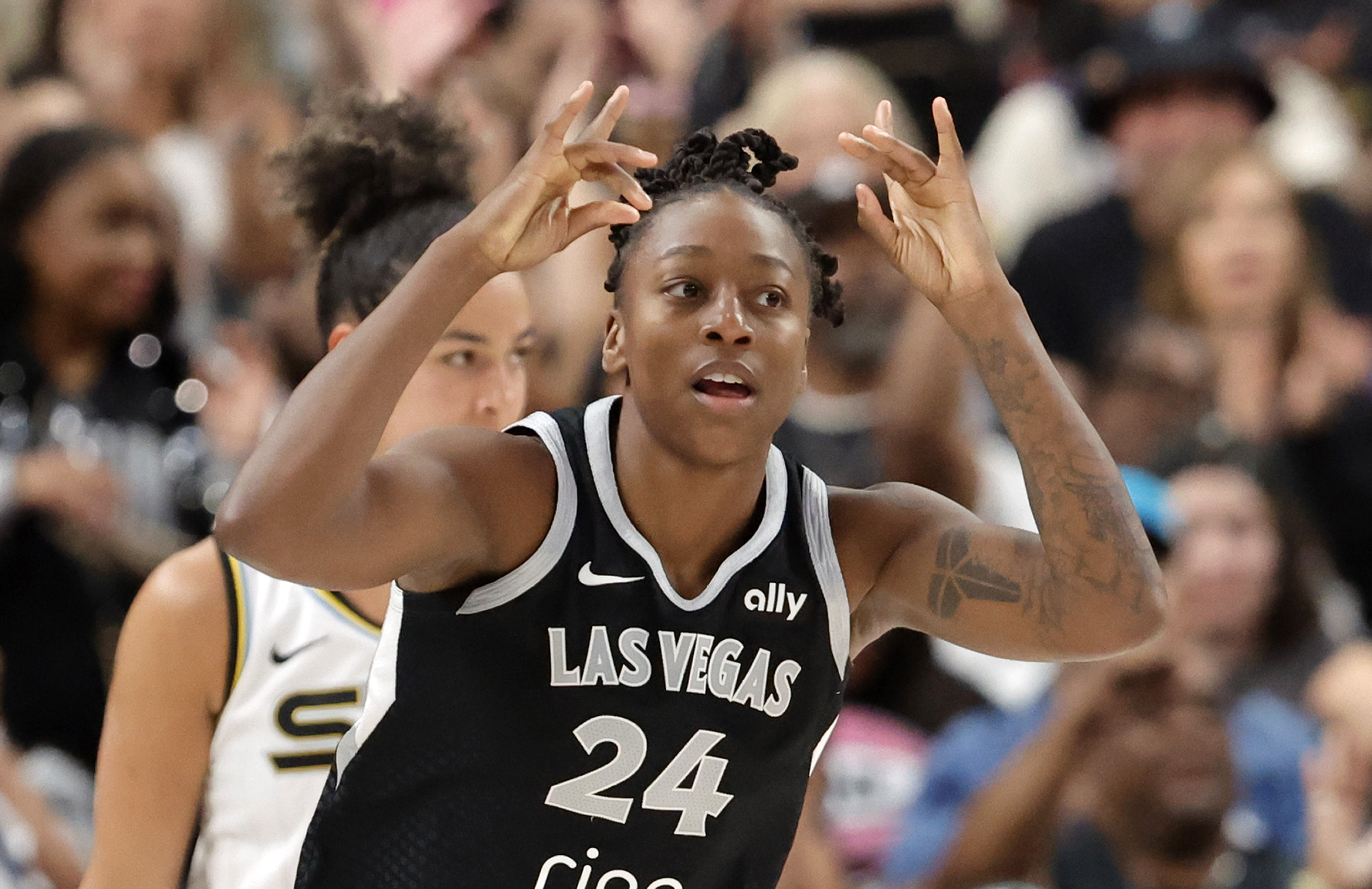 Las Vegas Aces guard Jewell Loyd (24) reacts after scoring a 3-point basket against the Chicago Sky during the second half of a WNBA basketball game Tuesday, Sept. 9, 2025, in Las Vegas. Loyd scored her 6,000th career point during the game.