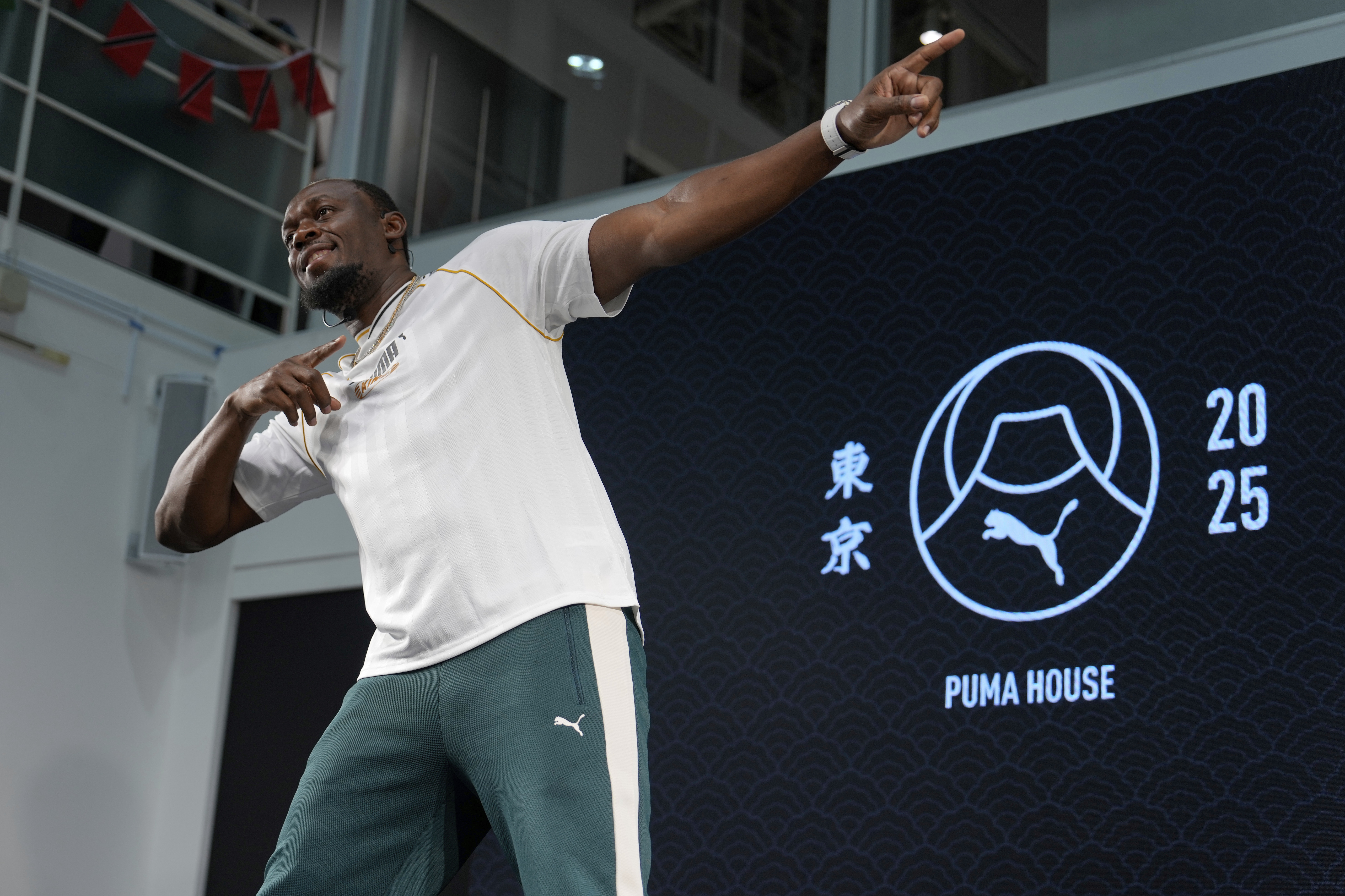 Former sprinter, Jamaica's Usain Bolt makes his signature pose at the end of a press conference ahead of the World Athletics Championships in Tokyo, Japan, Thursday, Sept. 11, 2025. 