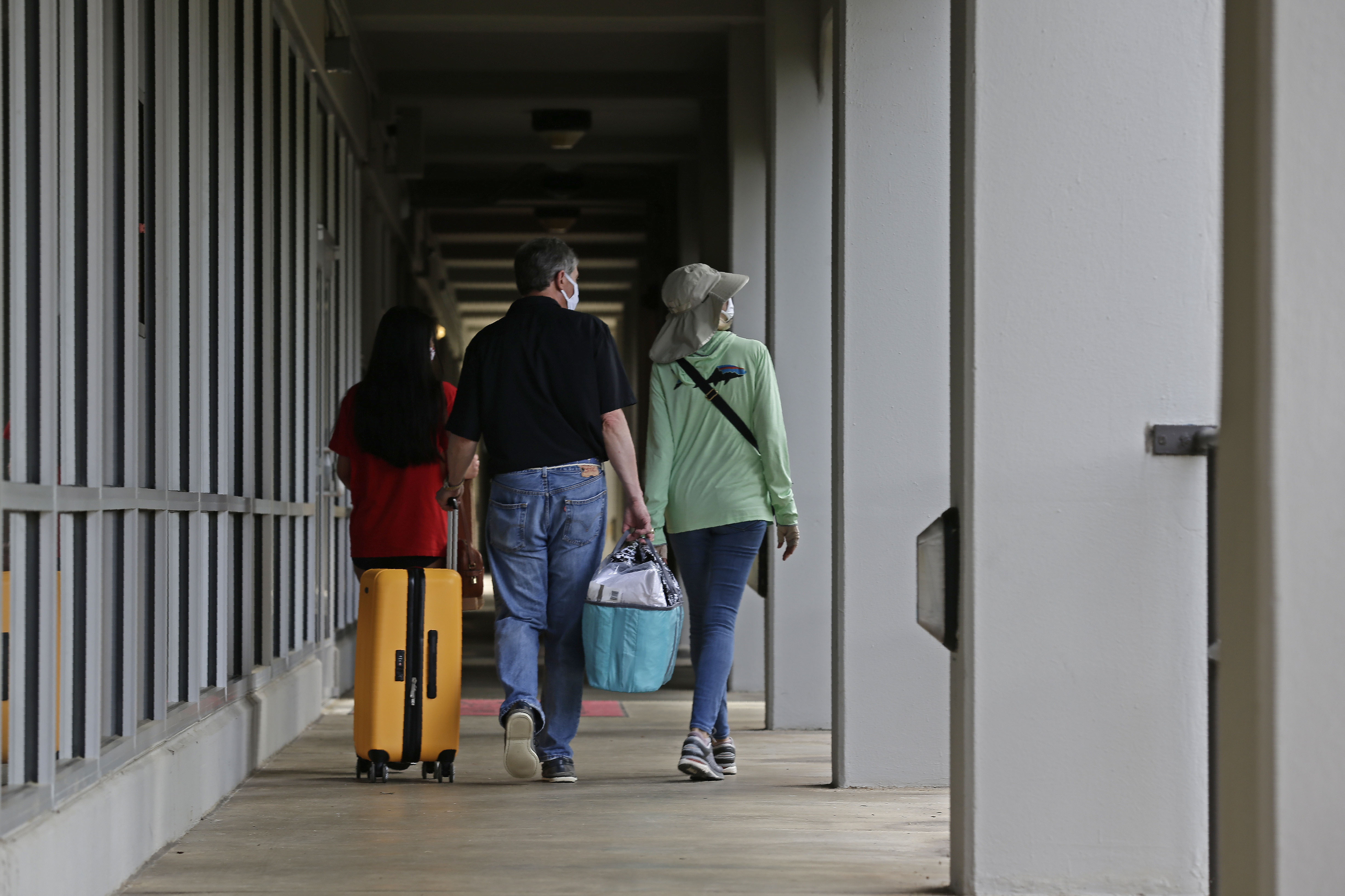A family walks down a corridor at Lee Hall at North Carolina State University in Raleigh, July 31, 2020. Experts are sharing how parents can cope with being "empty nesters."