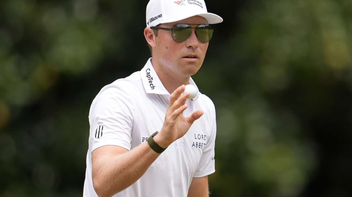 Ben Griffin waves to spectaots on the second green during the third round of the Tour Championship golf tournament, Saturday, Aug. 23, 2025, in Atlanta.