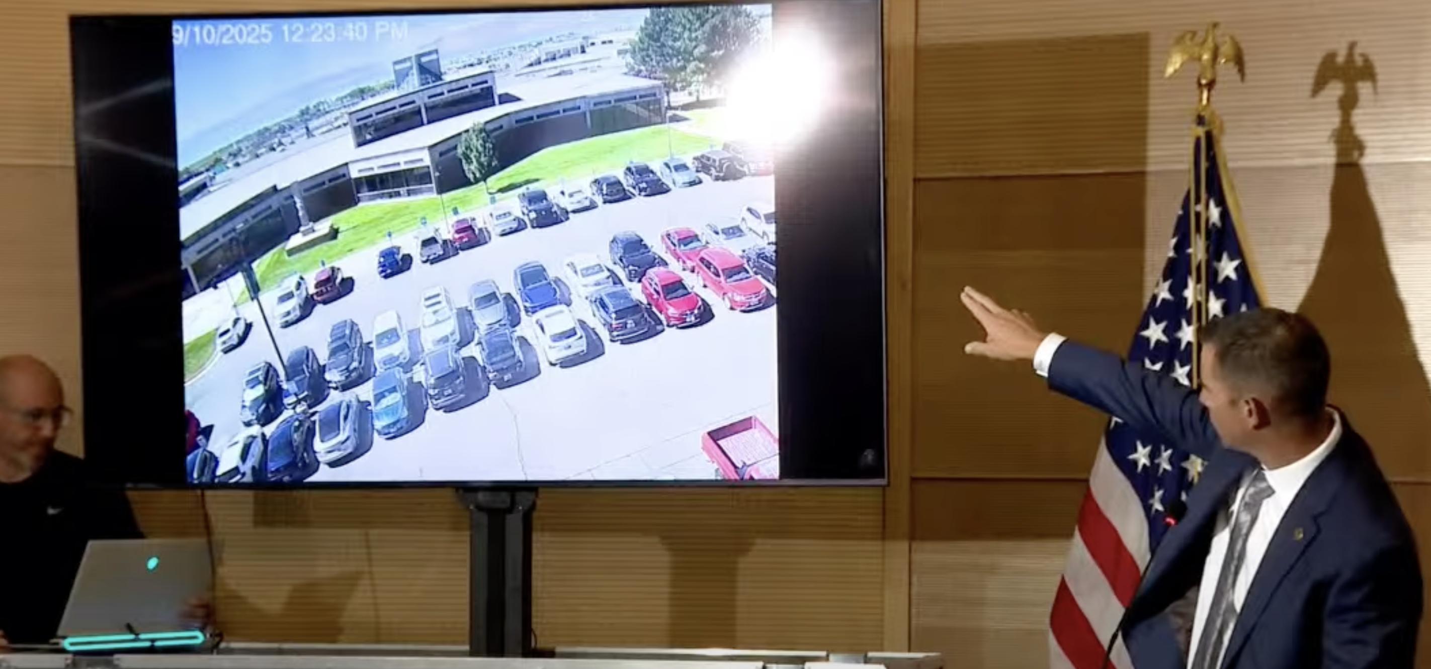 Public Safety Commissioner Beau Mason points to surveillance video of the suspected gunman in the killing of Charlie Kirk at Utah Valley University, during a news briefing at the university on Sept. 11.