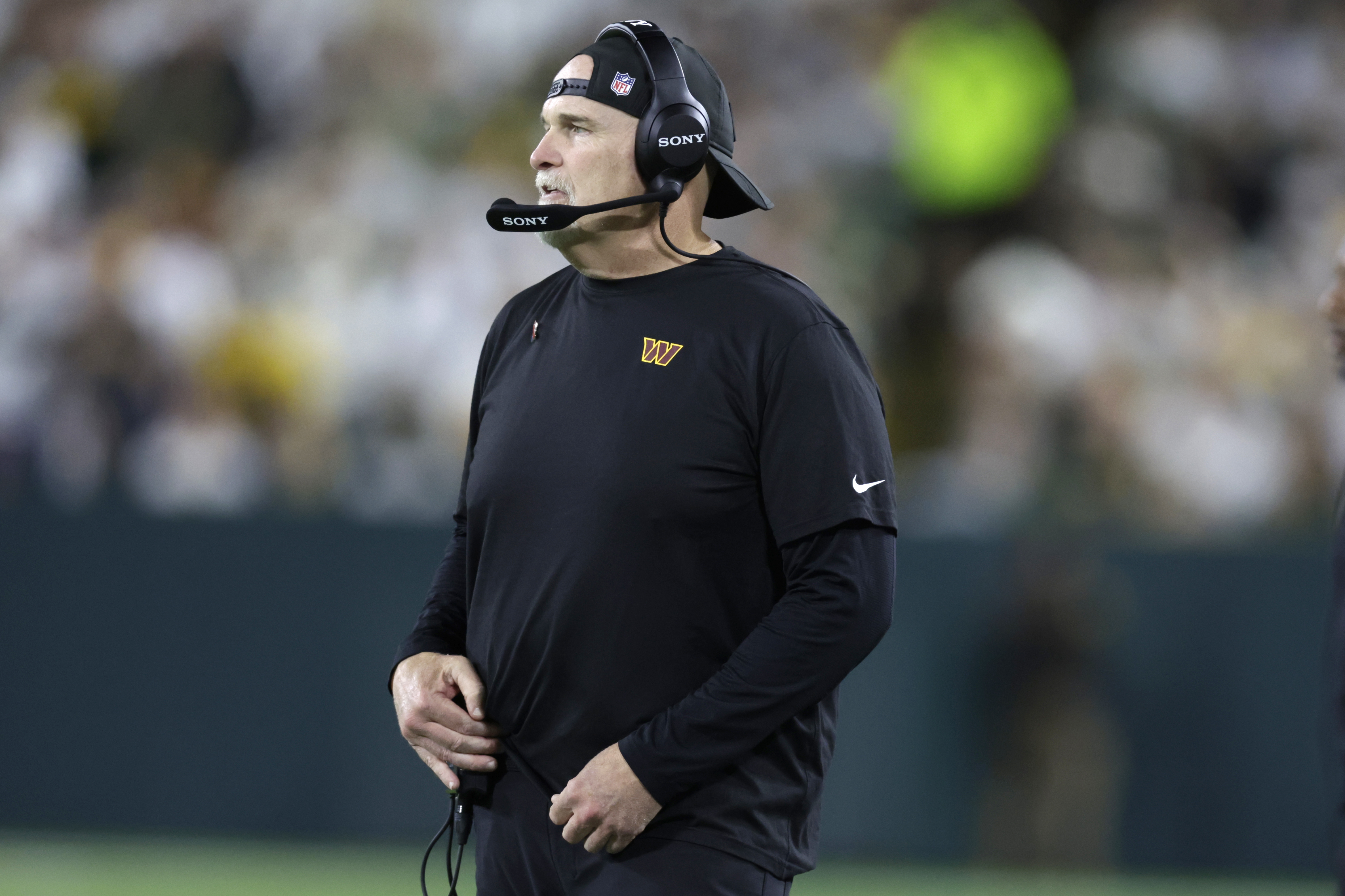 Washington Commanders head coach Dan Quinn watches from the sidelines during the second half of an NFL football game against the Green Bay Packers Thursday, Sept. 11, 2025, in Green Bay, Wis. 
