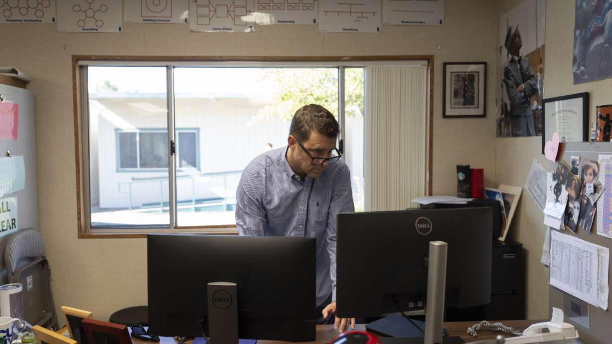 Casey Cuny, an English teacher at Valencia High School, works on his computer as he prepares for class in Santa Clarita, Calif., Aug. 27.