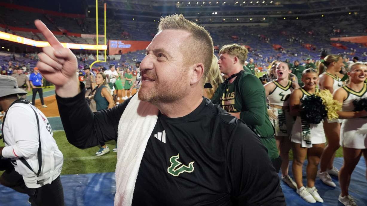 South Florida head coach Alex Golesh points to fans as he leaves the field as he celebrates defeating Florida in an NCAA college football game, Saturday, Sept. 6, 2025, in Gainesville, Fla.