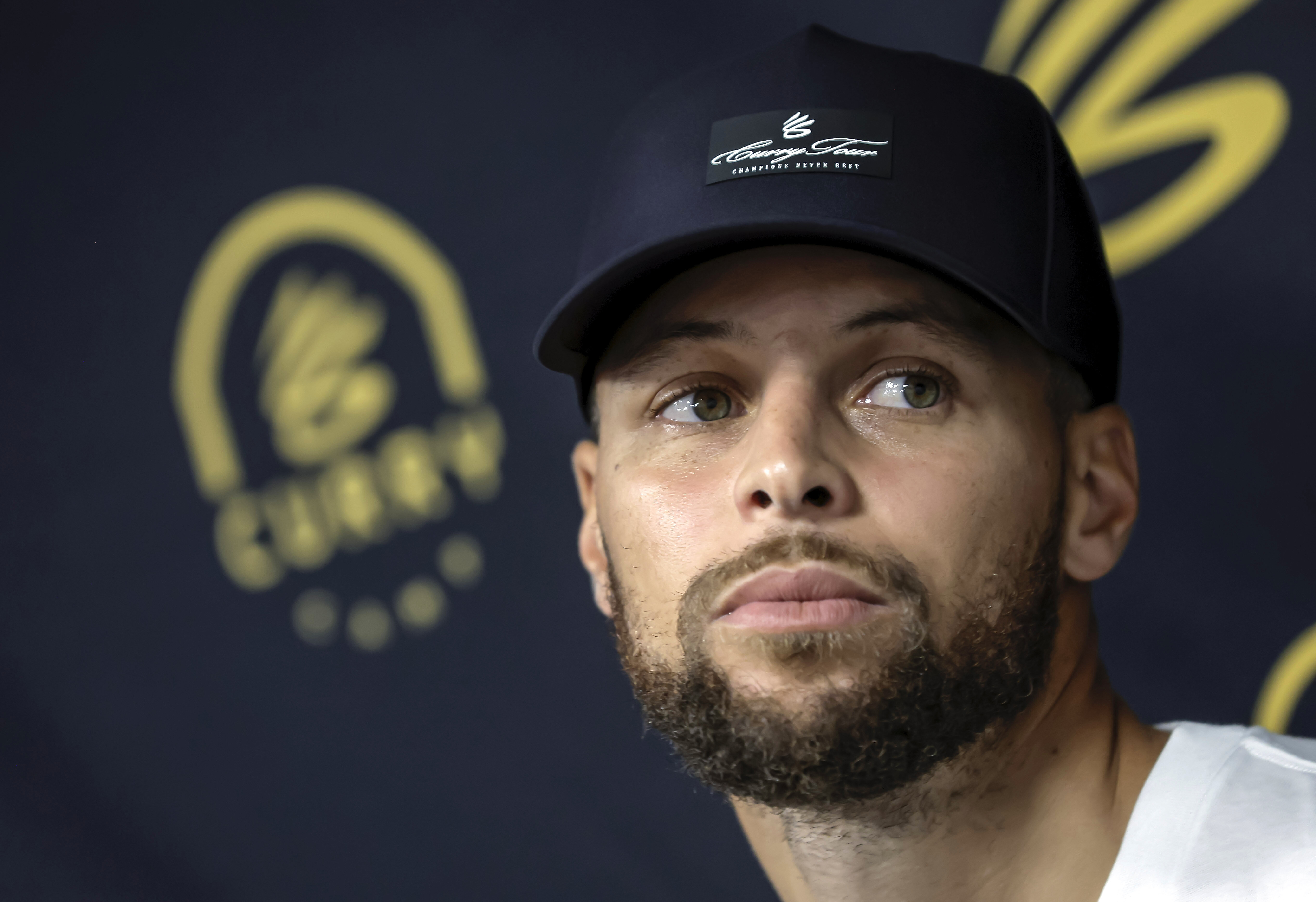 Golden State Warriors' Stephen Curry answers questions from reporters during a break from his Under Armour Camp at Arrillaga Family Gym in Menlo Park, Calif., on Thursday, Aug. 14, 2025. 