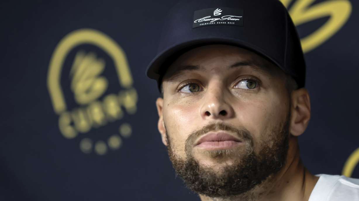 Golden State Warriors' Stephen Curry answers questions from reporters during a break from his Under Armour Camp at Arrillaga Family Gym in Menlo Park, Calif., on Thursday, Aug. 14, 2025.