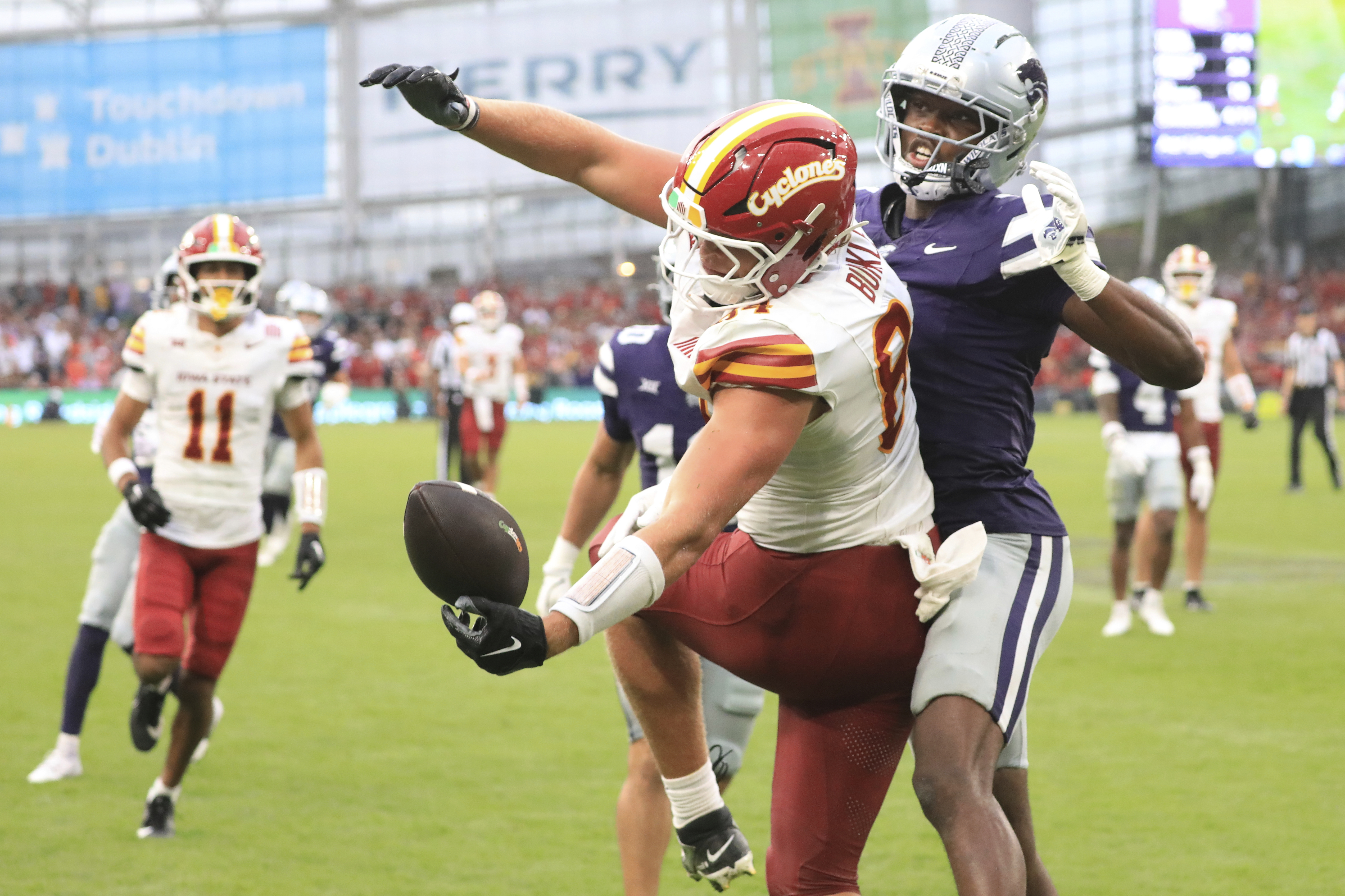 Iowa State Gabe Burkle, left, tries to catch the ball past Kansas State VJ Payne during an NCAA college football game between Iowa State and Kansas State in Dublin, Ireland Saturday, Aug. 23, 2025.