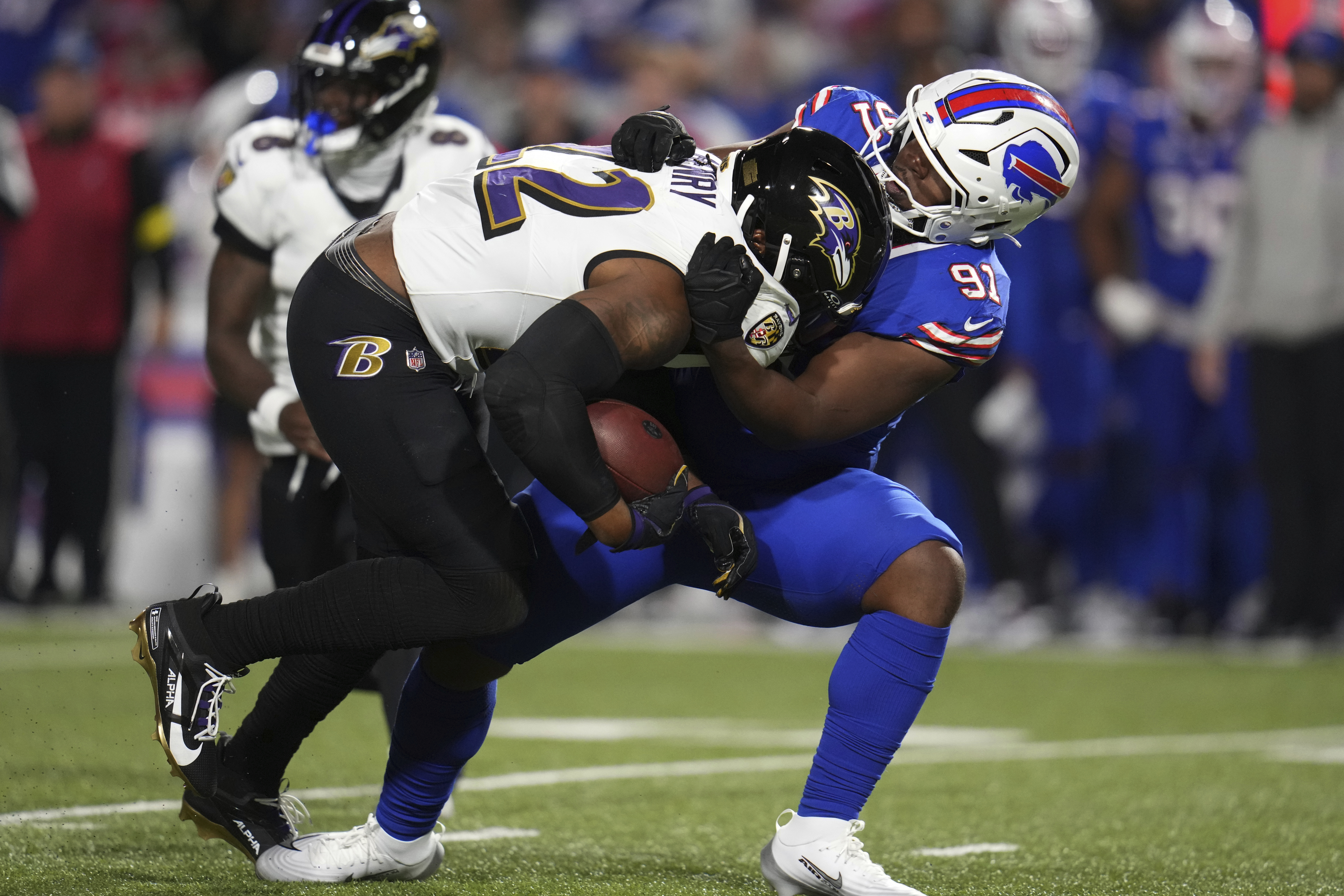 Baltimore Ravens running back Derrick Henry (22) is stopped by Buffalo Bills defensive tackle Ed Oliver (91) during the second half of an NFL football game in Orchard Park, N.Y., Sunday, Sept. 7, 2025. 
