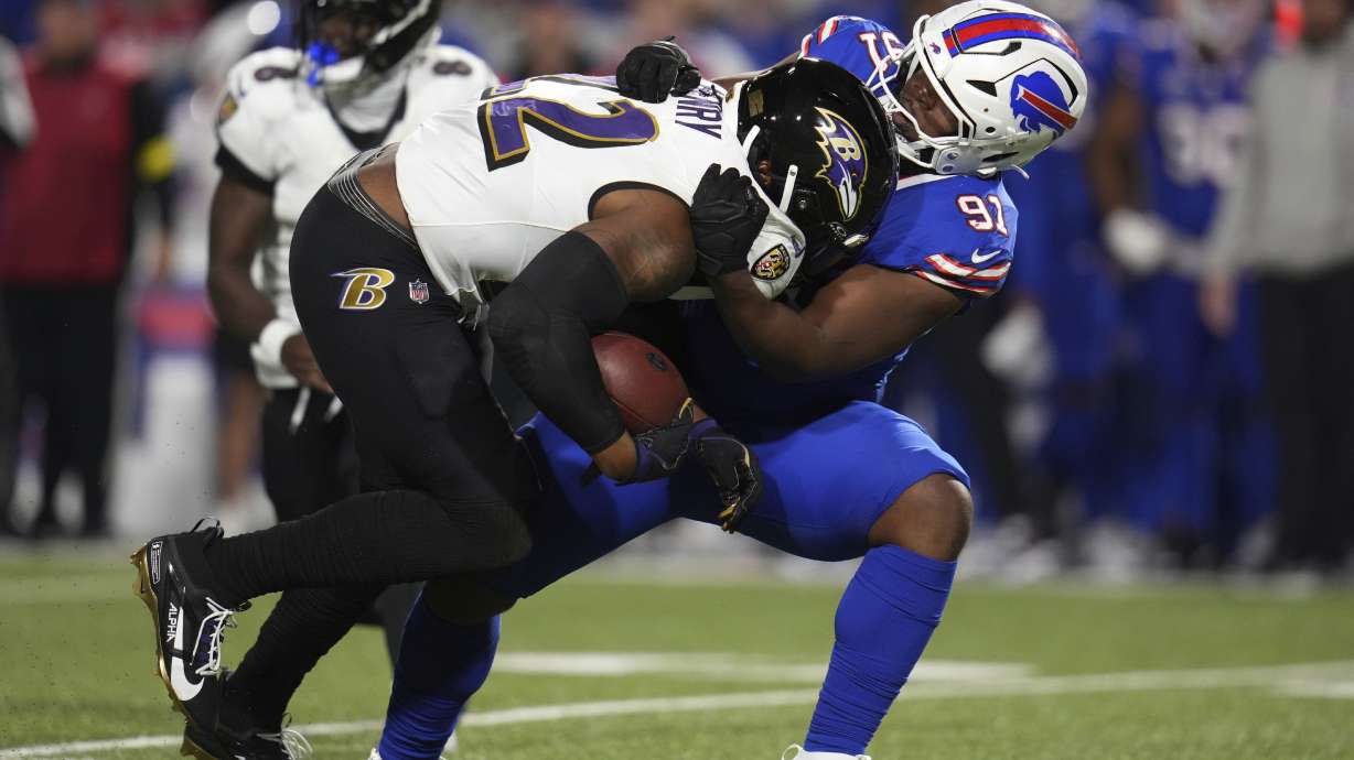 Baltimore Ravens running back Derrick Henry (22) is stopped by Buffalo Bills defensive tackle Ed Oliver (91) during the second half of an NFL football game in Orchard Park, N.Y., Sunday, Sept. 7, 2025.