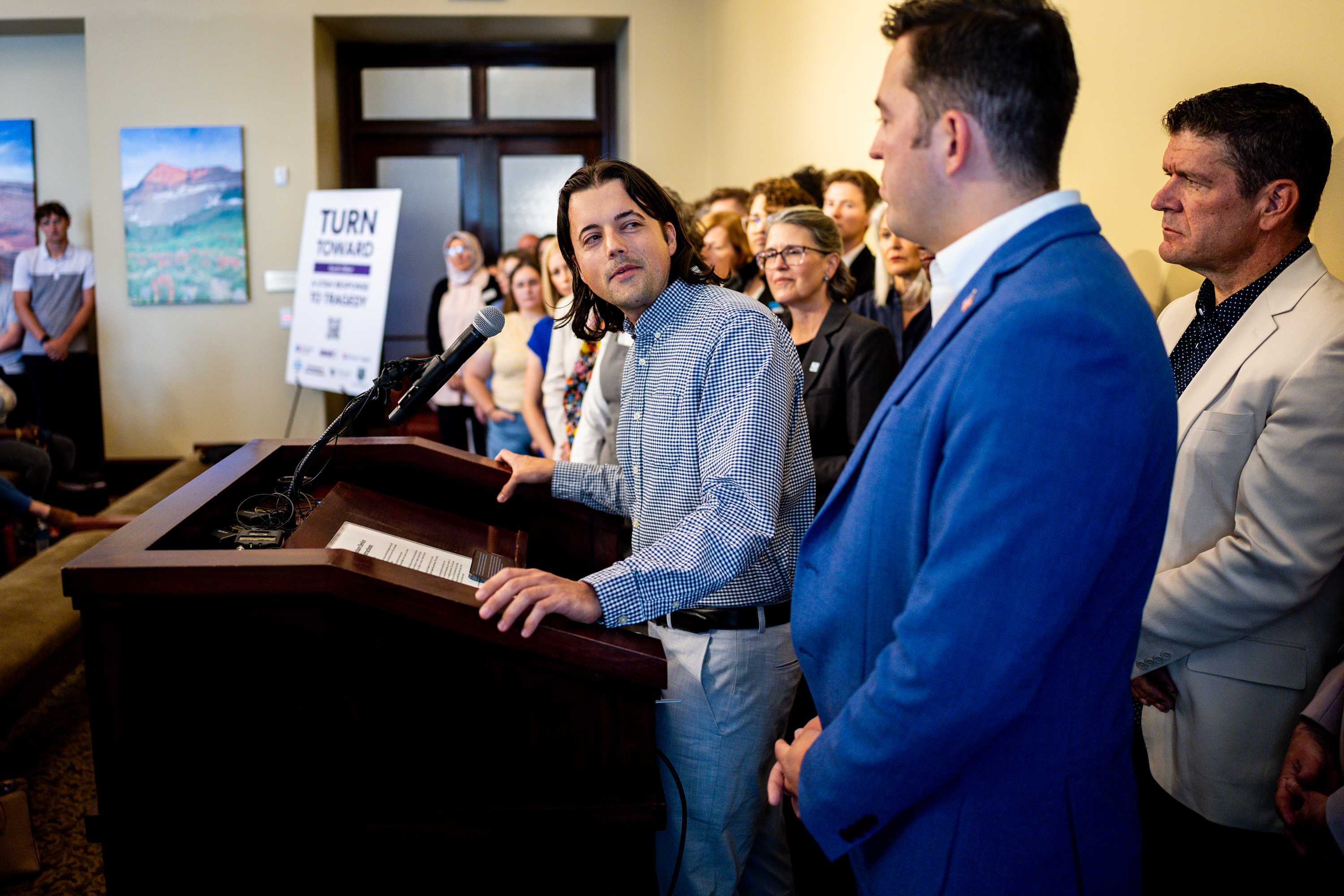 Jack Davis, of Young Democrats, center, looks at Zac Wilson, of Young Republicans, right, at the Utah Capitol in Salt Lake City on Friday.