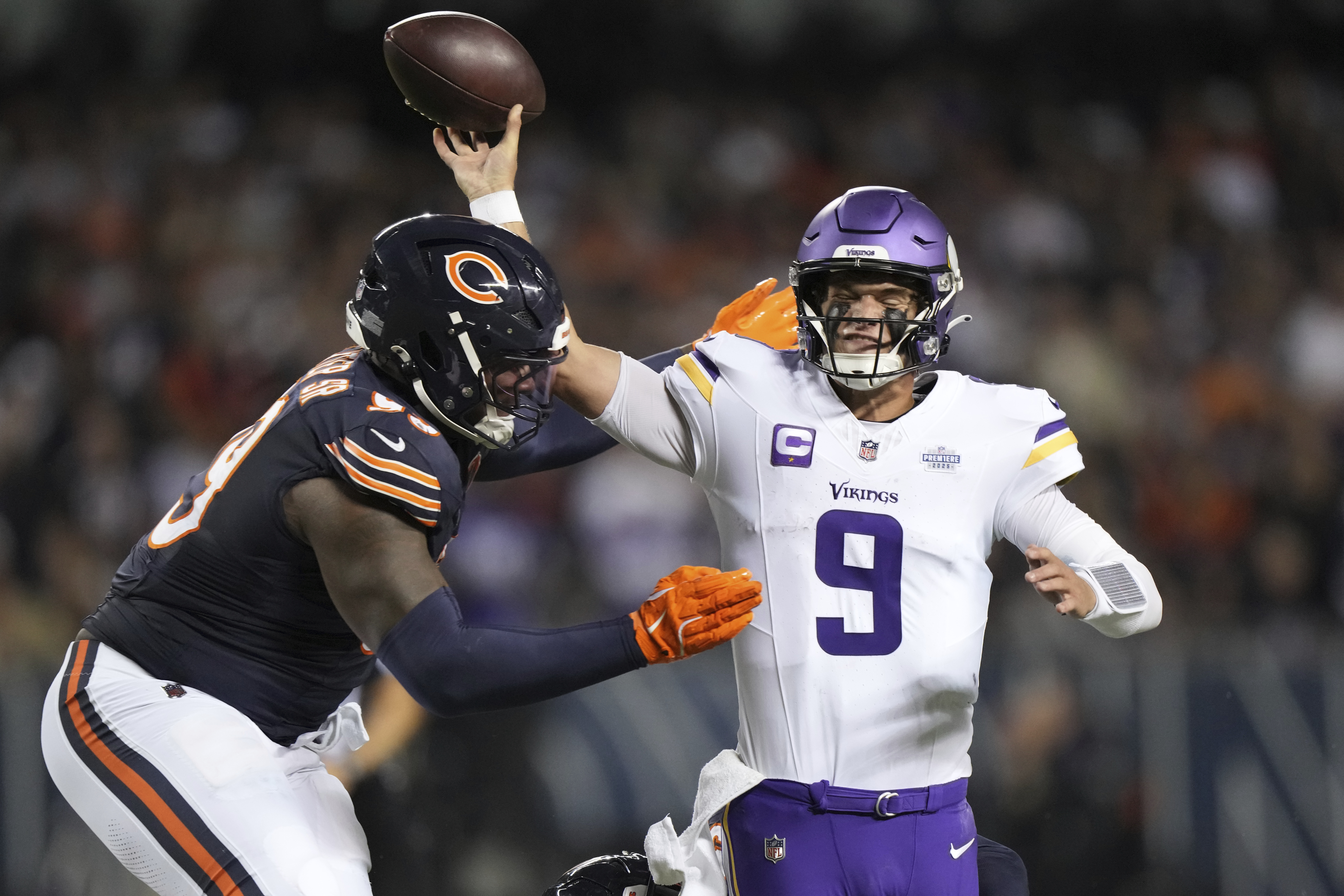 Minnesota Vikings quarterback J.J. McCarthy (9) throws under pressure from Chicago Bears defensive lineman Gervon Dexter Sr. during the second half of an NFL football game Monday, Sept. 8, 2025, in Chicago. 