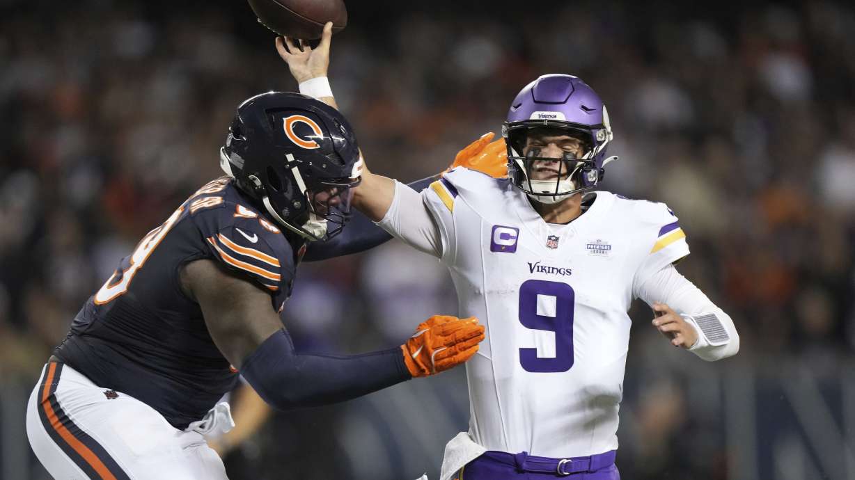 Minnesota Vikings quarterback J.J. McCarthy (9) throws under pressure from Chicago Bears defensive lineman Gervon Dexter Sr. during the second half of an NFL football game Monday, Sept. 8, 2025, in Chicago.