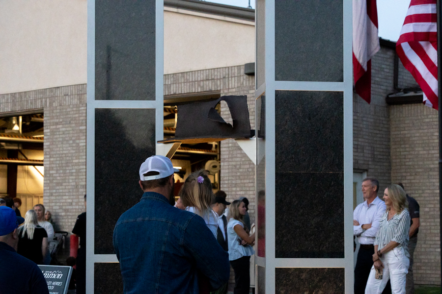 A father and daugher looking at the new 9/11 monument in front of the Bonneville County Fire District No. 1 building, Thursday. The monument contains the last piece of steel from the original twin towers of the World Trade Center.