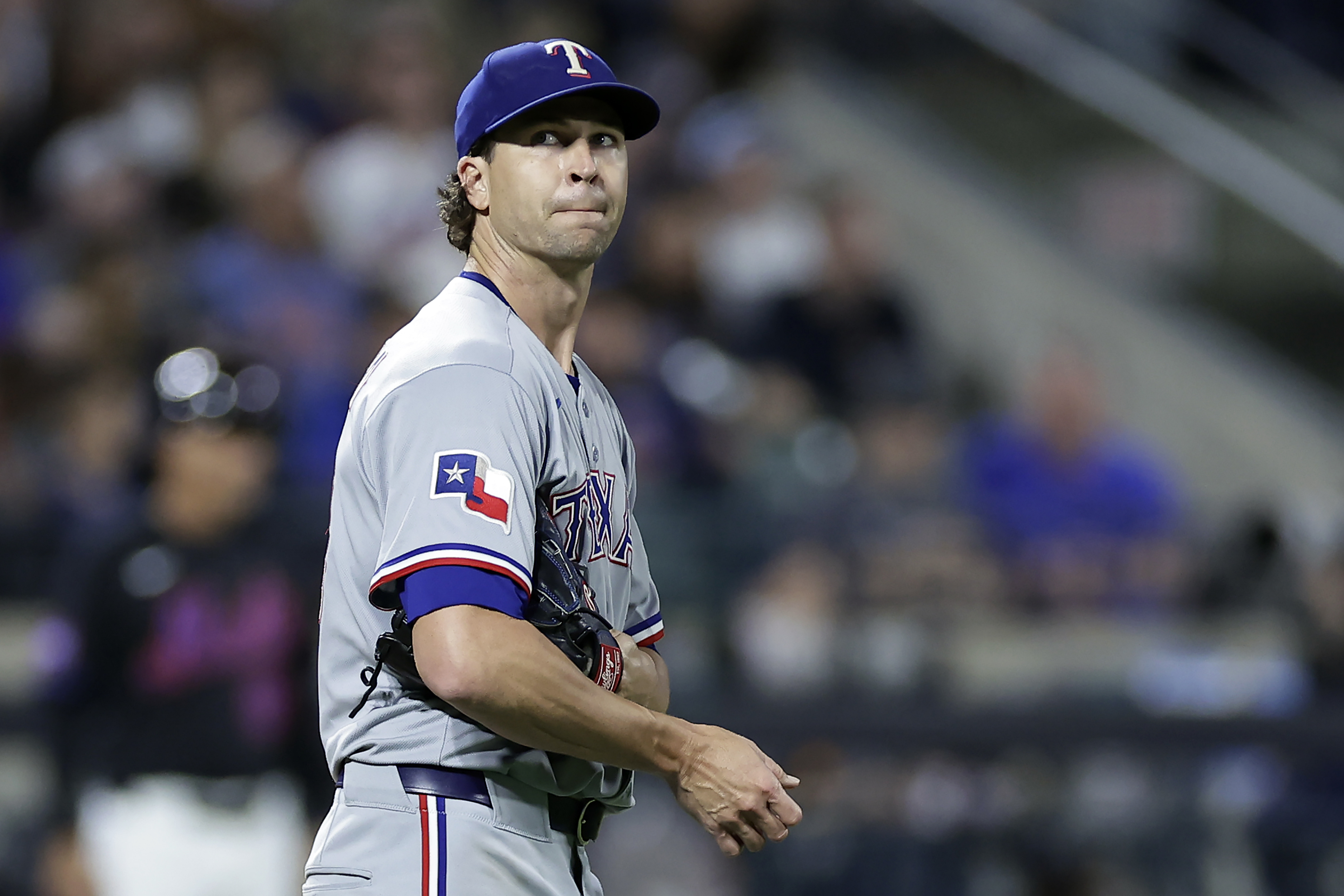 Texas Rangers pitcher Jacob deGrom reacts during the fifth inning of a baseball game against the New York Mets, Friday, Sept. 12, 2025, in New York. 