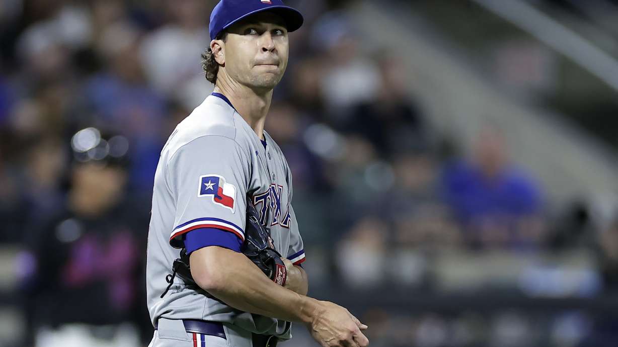 Texas Rangers pitcher Jacob deGrom reacts during the fifth inning of a baseball game against the New York Mets, Friday, Sept. 12, 2025, in New York.