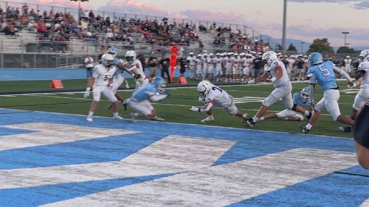 Woods Cross running back Ryan Miller scores a touchdown during the Wildcats' 27-10 win over Westlake.