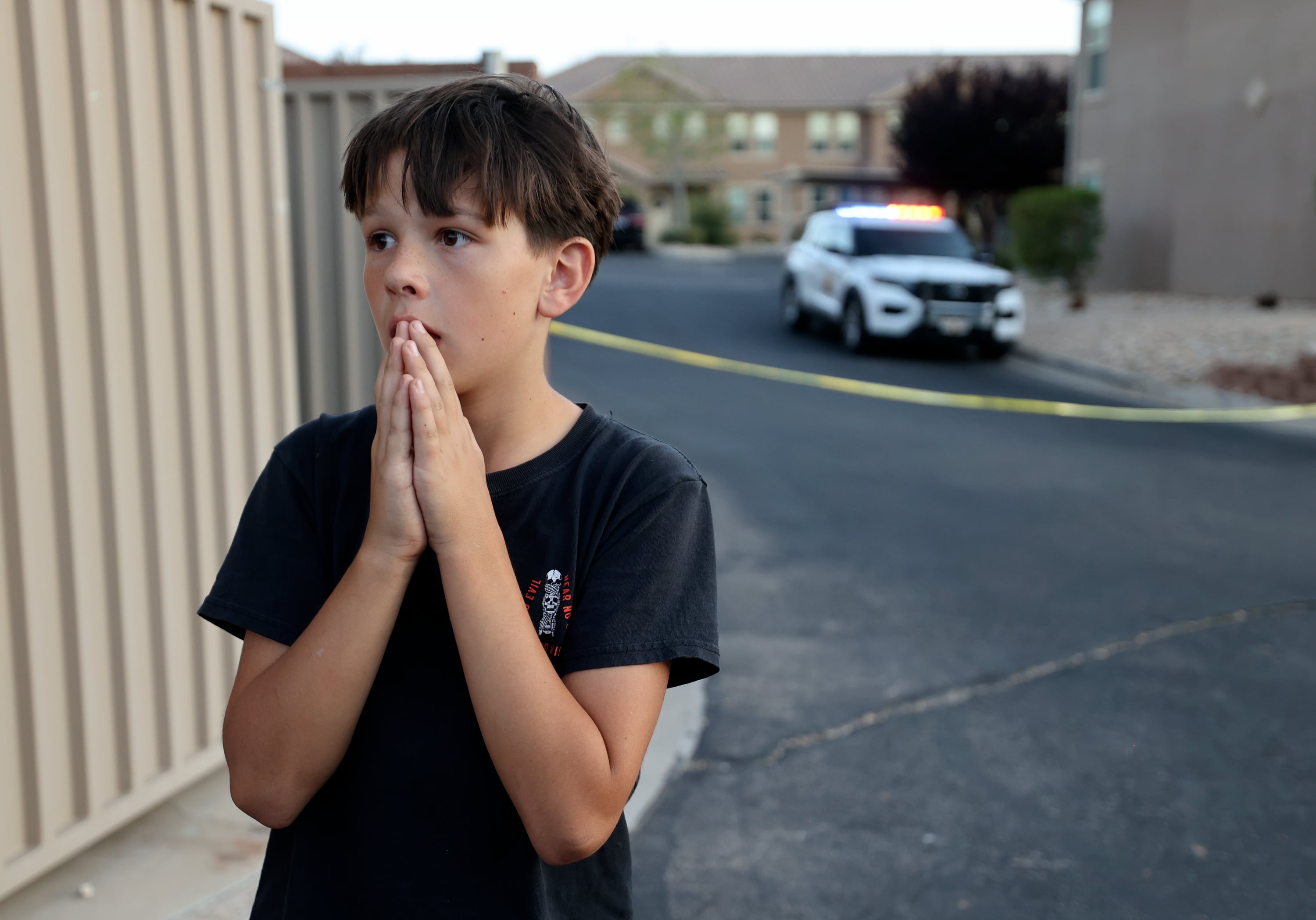 Aiden Bartley, 11, takes in the scene around him and continues to react to the news that his neighbor Tyler Robinson is the suspected killer of Charlie Kirk, in St. George on Friday. Robinson bought chocolates from Bartley for Bartley's school fundraiser in the past.