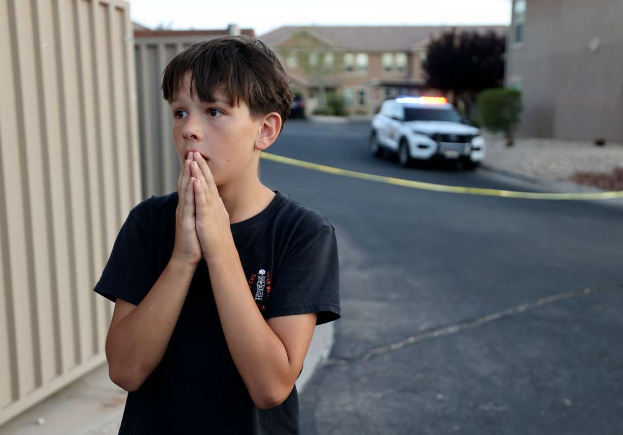 Aiden Bartley, 11, takes in the scene around him and continues to react to the news that his neighbor Tyler Robinson is the suspected killer of Charlie Kirk, in St. George on Friday. Robinson bought chocolates from Bartley for Bartley's school fundraiser in the past.
