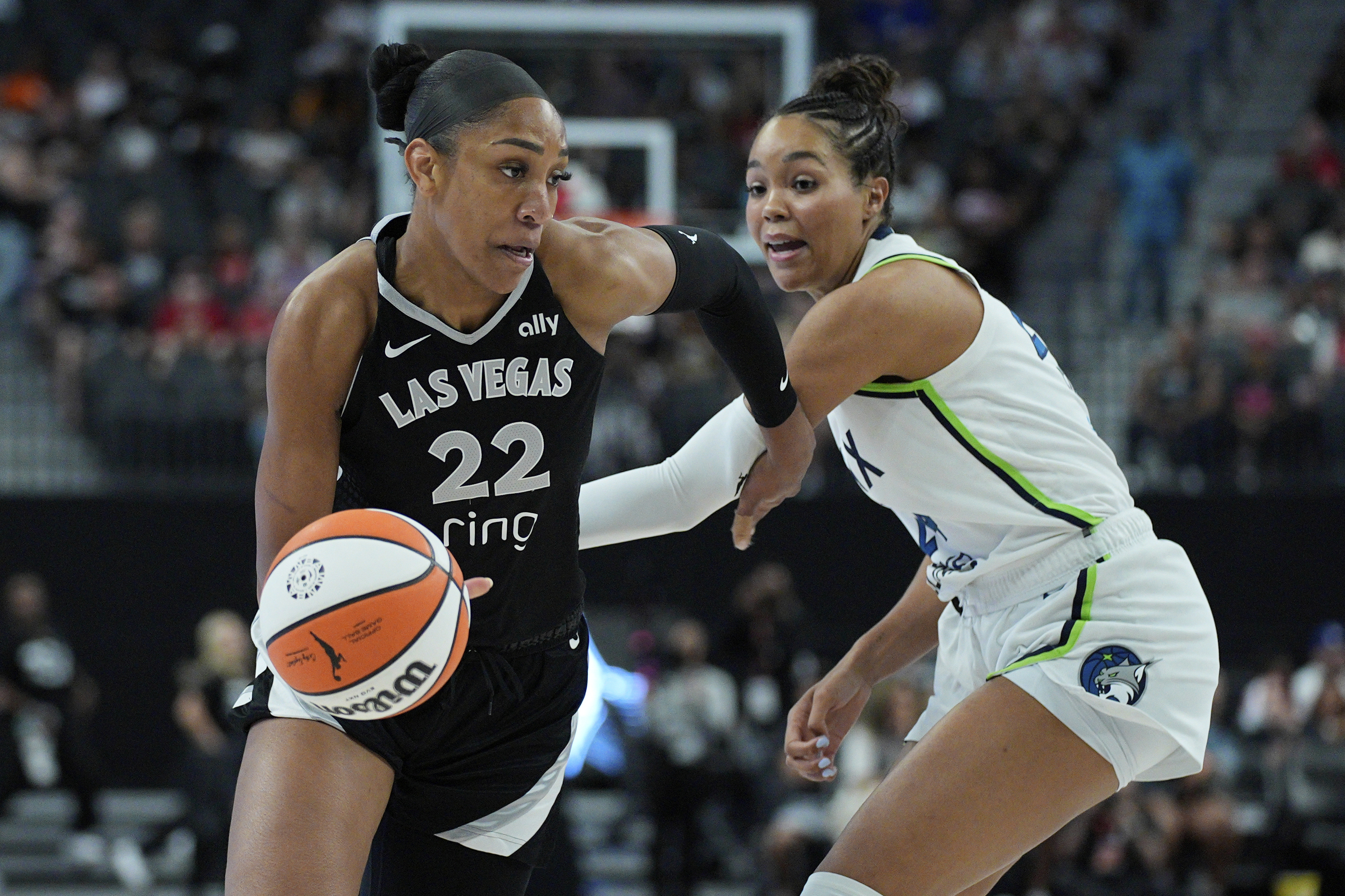Las Vegas Aces center A'ja Wilson (22) drives around Minnesota Lynx forward Napheesa Collier (24) during the first half of a WNBA basketball game Thursday, Sept. 4, 2025, in Las Vegas. 