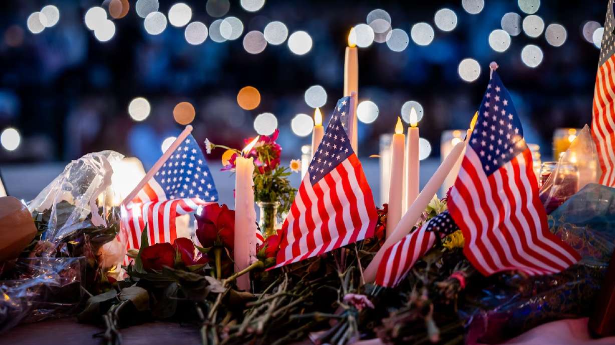 People leave candles, flowers and American flags beneath a photo of Charlie Kirk at a vigil at City Center Park in Orem on Thursday, Sept. 11. Charlie Kirk, the CEO and co-founder of the conservative youth organization Turning Point USA, was fatally shot during Turning Point’s visit to Utah Valley University on Wednesday.