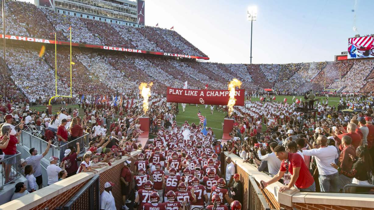 Oklahoma runs onto the field before an NCAA college football game against Michigan on Saturday, Sept. 6, 2025, in Norman, Okla.