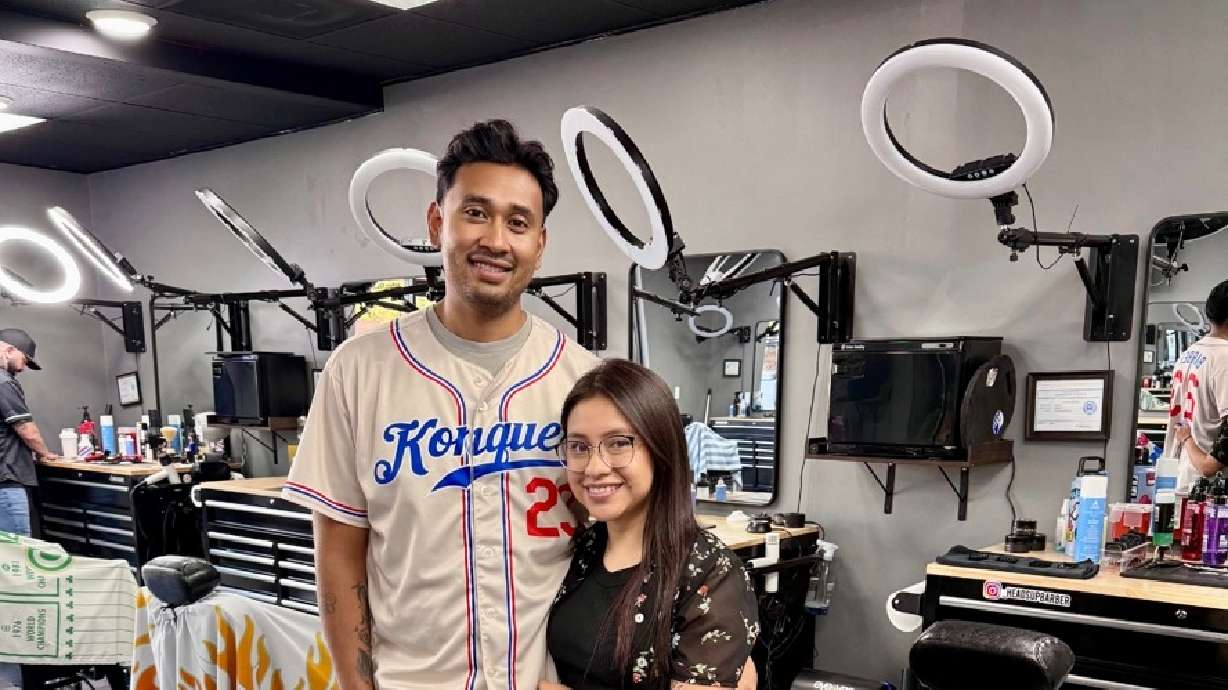 Konquer Barbershop co-owner Kevin Romero and his wife, Carolina Sanchez, in St. George. The shop's proceeds will fund scholarships for future barbers.