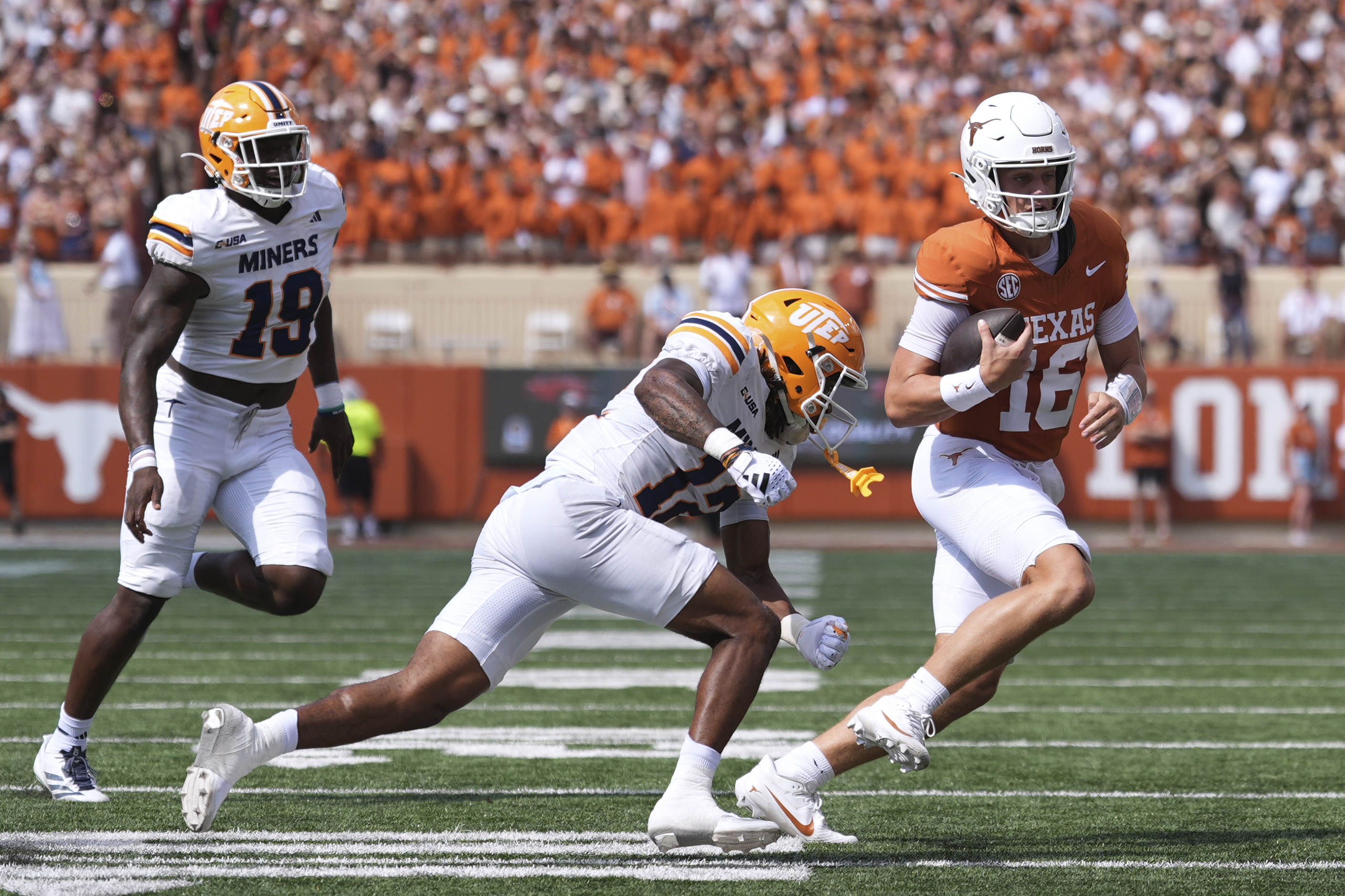 Texas quarterback Arch Manning (16) runs from UTEP linebacker Donte Thompson (12) and defensive lineman Ashaad Hall (19) during the first half of an NCAA college football game in Austin, Texas, Saturday, Sept. 13, 2025. 