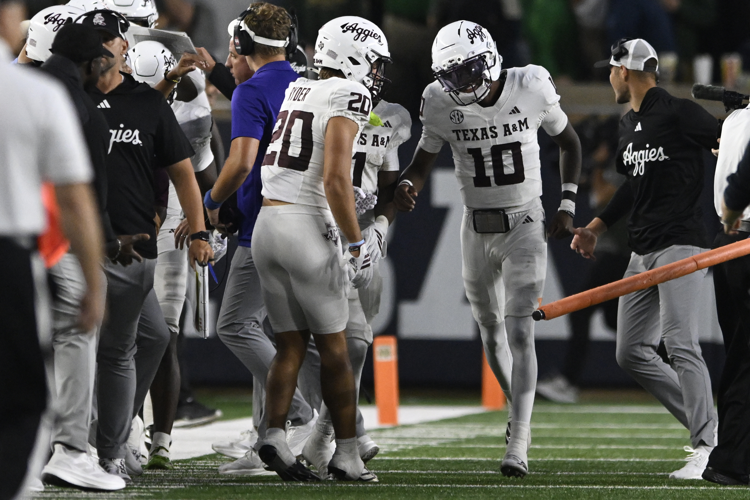 Texas A&M quarterback Marcel Reed (10) celebrates with teammates on the sideline after wide receiver Mario Craver caught a touchdown pass during the first quarter of an NCAA football game against Notre Dame, Saturday, Sept. 13, 2025, in South Bend, Ind. 