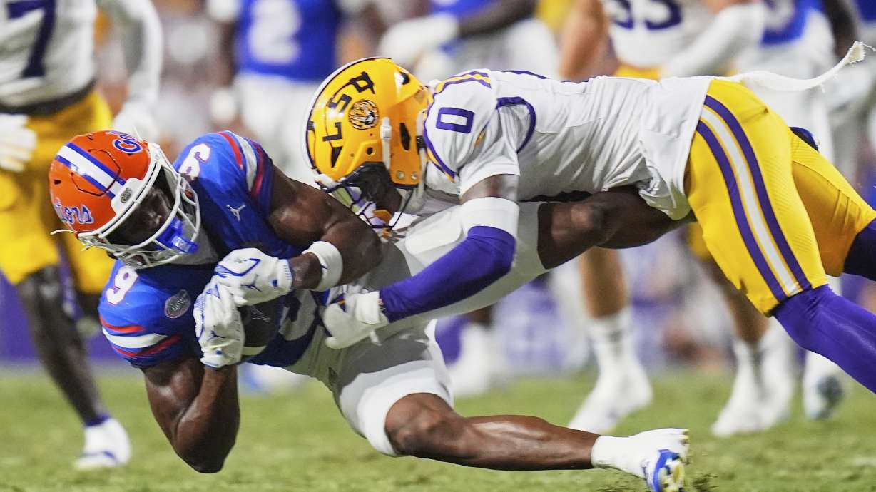 Florida wide receiver J. Michael Sturdivant (9) pulls in a pass against LSU safety Tamarcus Cooley (0) in the second half of an NCAA college football game, Saturday, Sept. 13, 2025, in Baton Rouge, La.