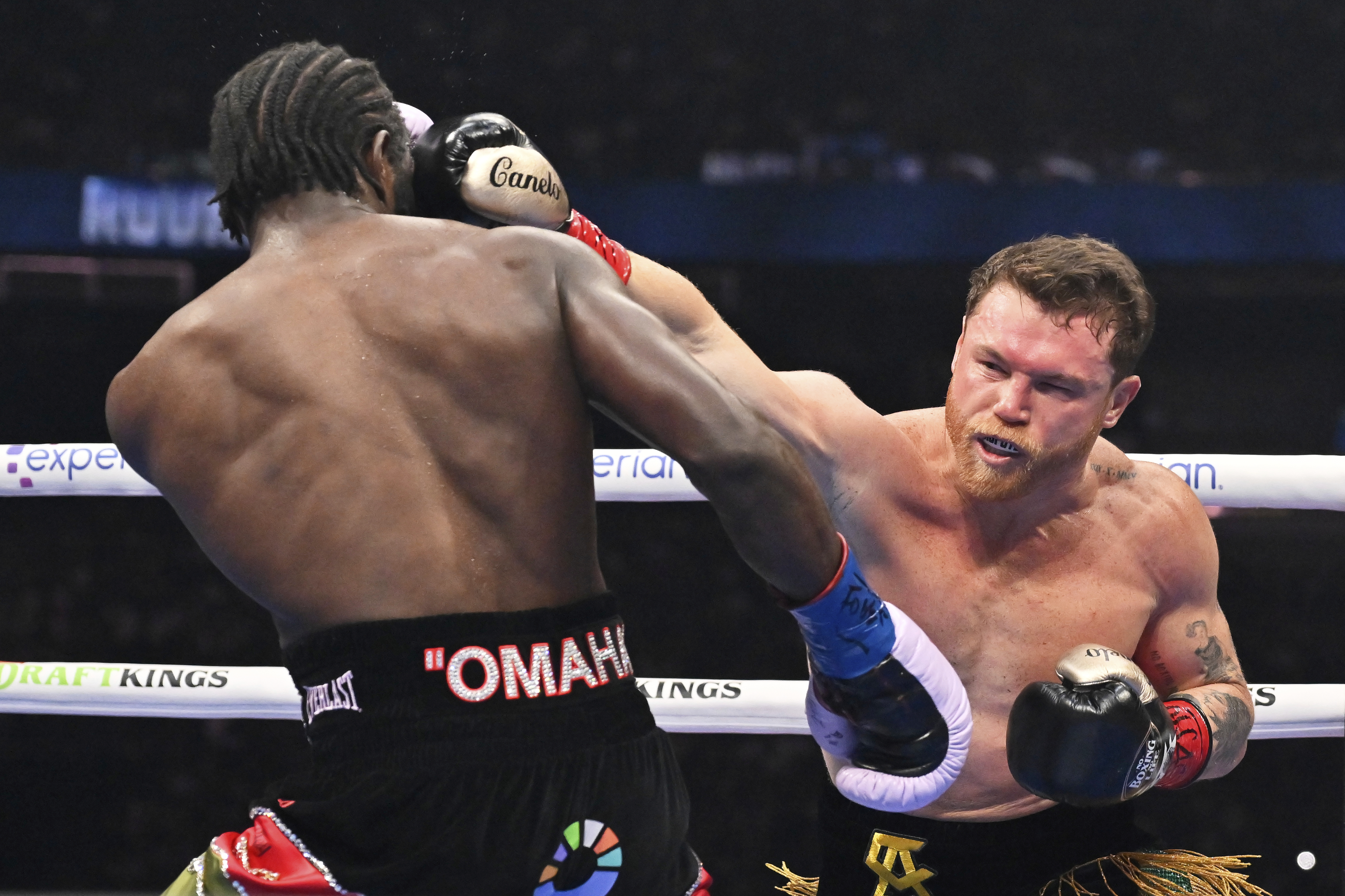 Canelo Alvarez, right, punches Terence Crawford during an undisputed super middleweight championship boxing match in Las Vegas, Saturday, Sept. 13, 2025. 