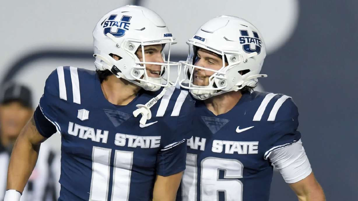 Utah State wide receiver Braden Pegan (11) and quarterback Bryson Barnes (16) celebrate after Pegan scored a touchdown from a Barnes pass against Air Force in the second half Saturday in Logan.