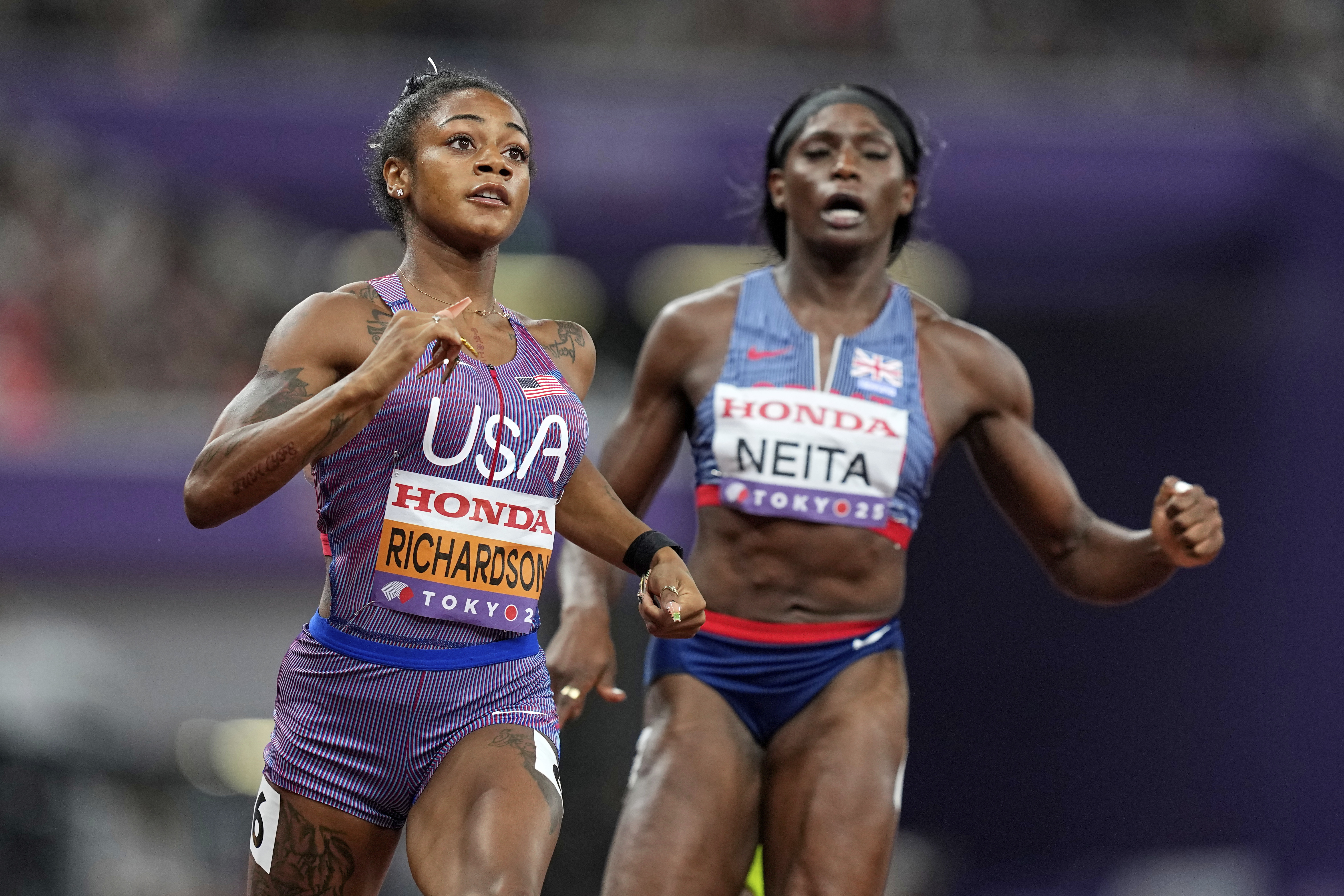 United States' Sha'Carri Richardson and Britain's Daryll Neita finish a women's 100 meters semifinal at the World Athletics Championships in Tokyo, Sunday, Sept. 14, 2025. 