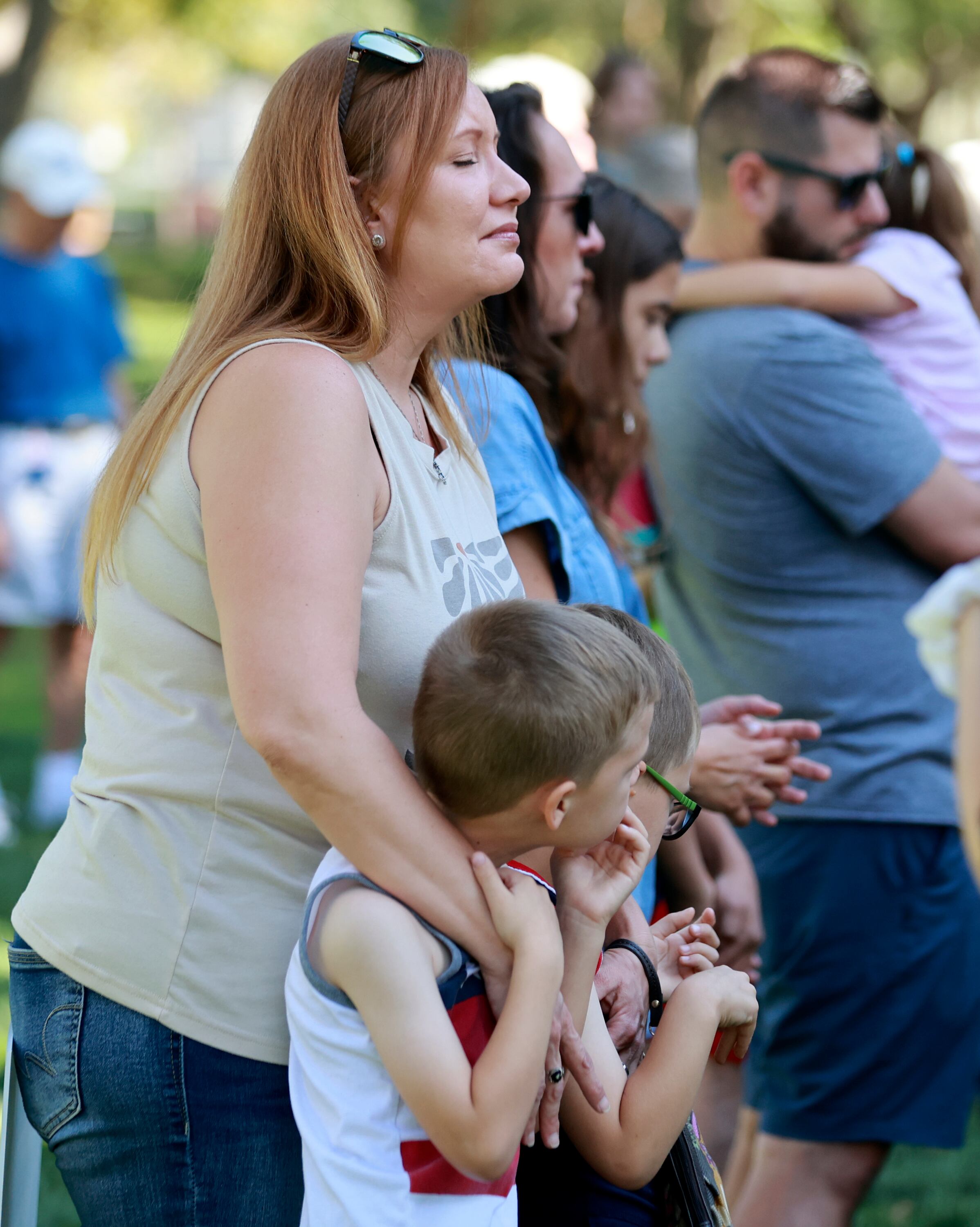 Nicole Rossetti prays with her twin boys during an ecumenical community prayer gathering called Pray Without Ceasing, held in the wake of the shooting of Charlie Kirk, at Vernon Worthen Park in St. George on Saturday. Tyler Robinson, who is accused of killing Kirk, lives nearby in Washington. Kirk was a conservative activist and the founder and president of Turning Point USA.