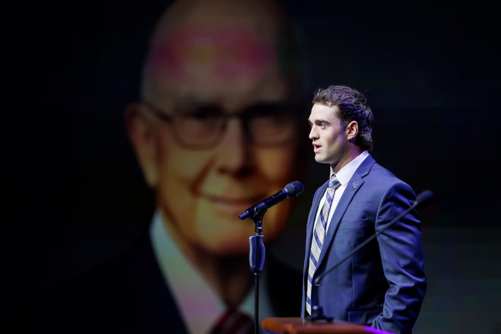 BYU wide receiver Chase Roberts reads a quote from President Dallin H. Oaks during the university's Sesquicentennial Kickoff devotional at the Marriott Center in Provo on Tuesday, Sept. 9. 