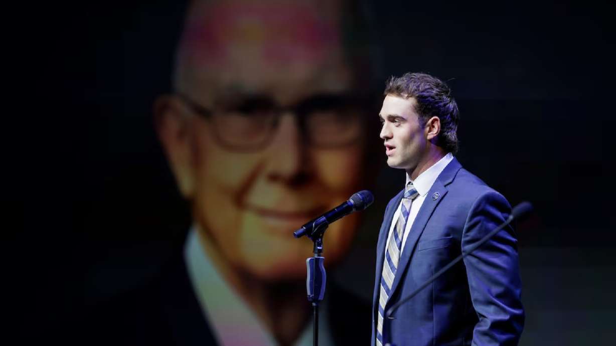 BYU wide receiver Chase Roberts reads a quote from President Dallin H. Oaks during the university's Sesquicentennial Kickoff devotional at the Marriott Center in Provo on Tuesday, Sept. 9.