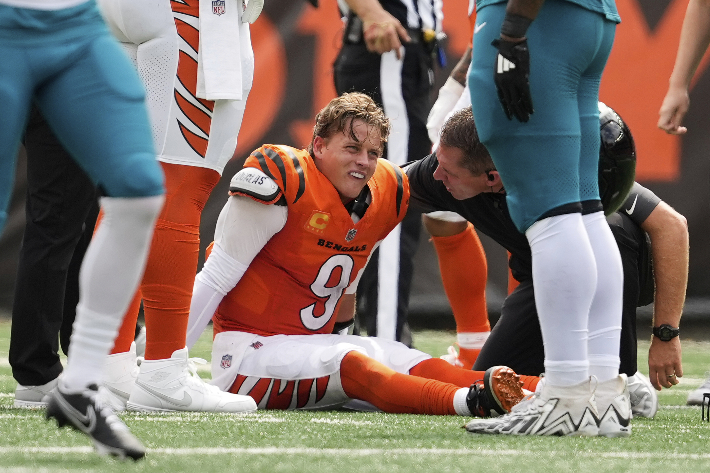 Cincinnati Bengals quarterback Joe Burrow (9) grimaces aft being sacked by Jacksonville Jaguars defensive tackle Arik Armstead (91) during the first half of an NFL football game, Saturday, Sept. 14, 2024, in Cincinnati. 
