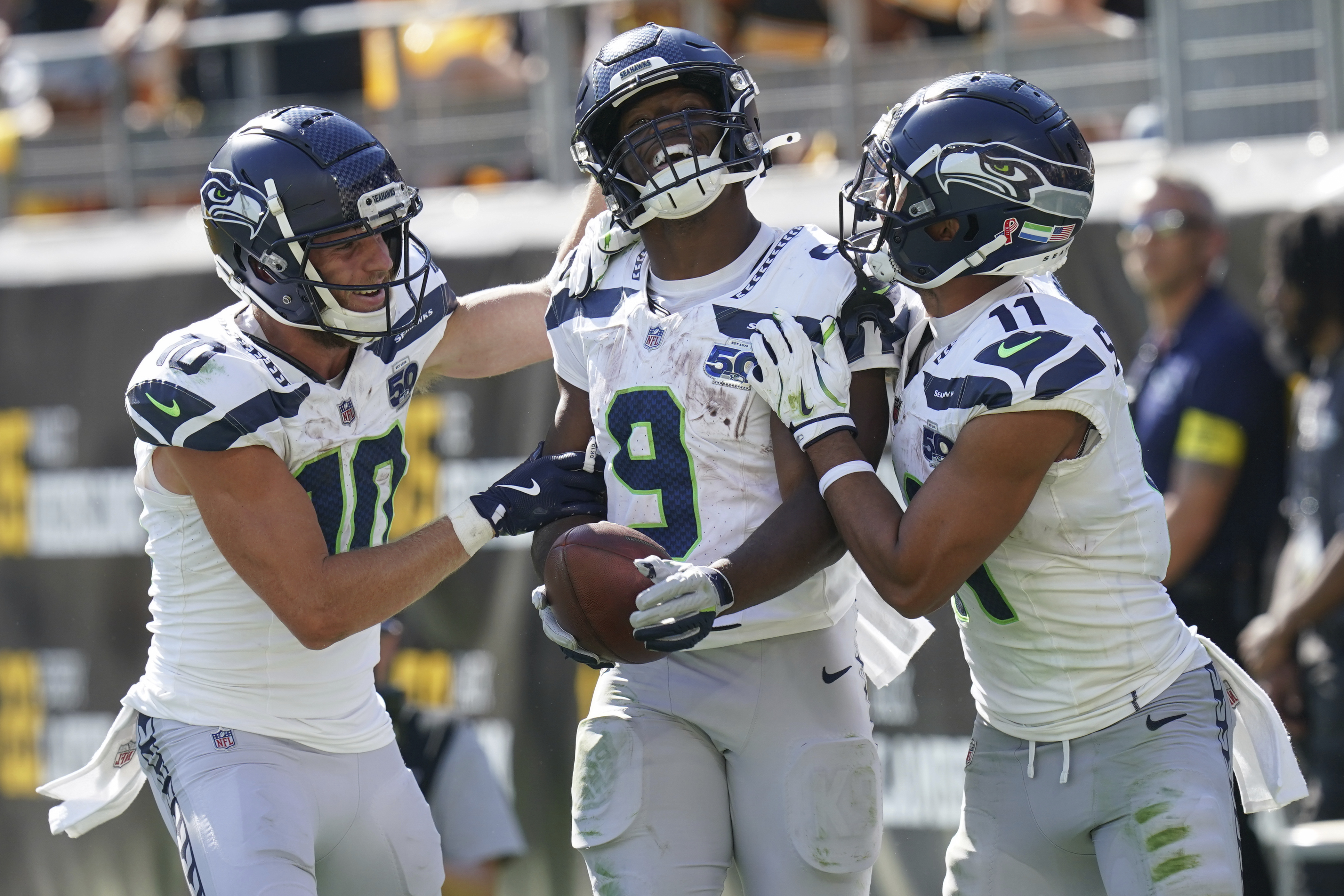 Seattle Seahawks running back Kenneth Walker III (9) celebrates a touchdown with wide receiver Cooper Kupp (10) and wide receiver Jaxon Smith-Njigba (11) during the second half of an NFL football game against the Pittsburgh Steelers, Sunday, Sept. 14, 2025, in Pittsburgh. 