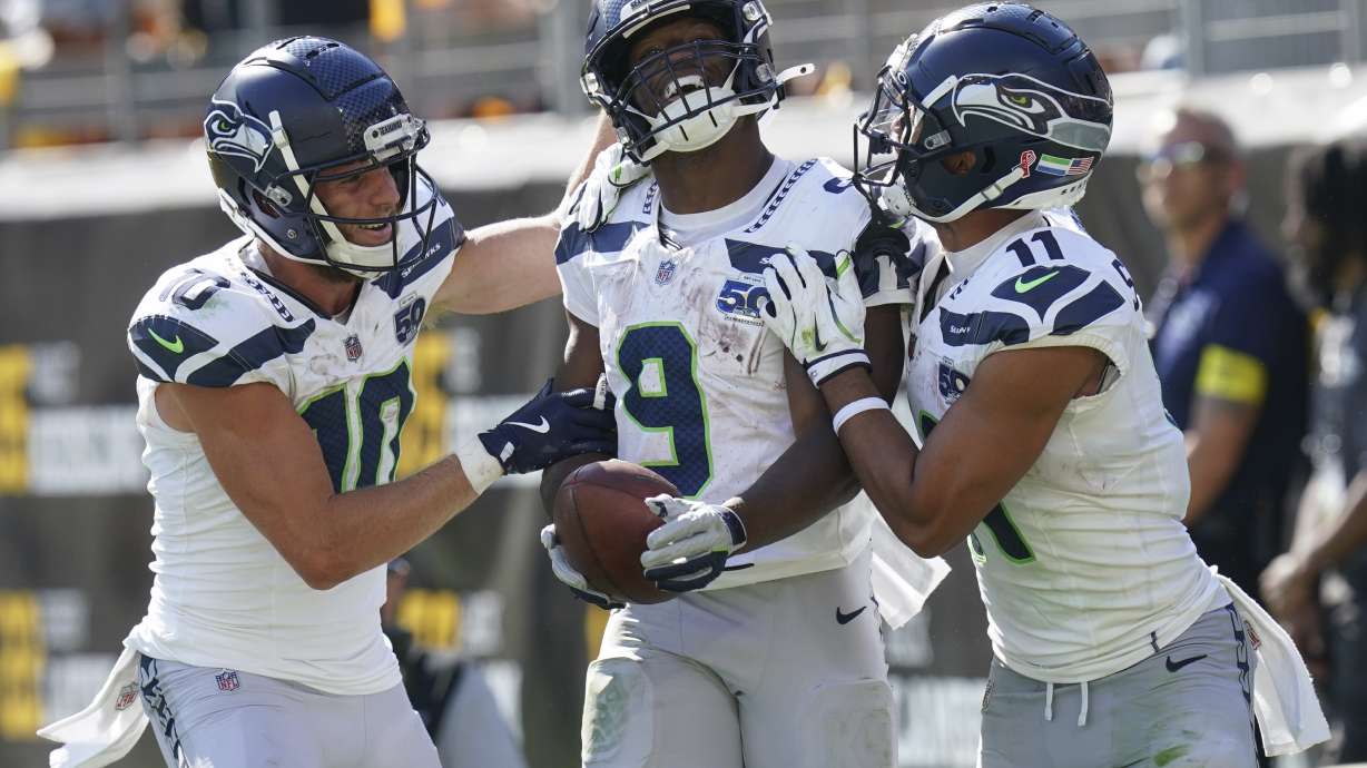 Seattle Seahawks running back Kenneth Walker III (9) celebrates a touchdown with wide receiver Cooper Kupp (10) and wide receiver Jaxon Smith-Njigba (11) during the second half of an NFL football game against the Pittsburgh Steelers, Sunday, Sept. 14, 2025, in Pittsburgh.